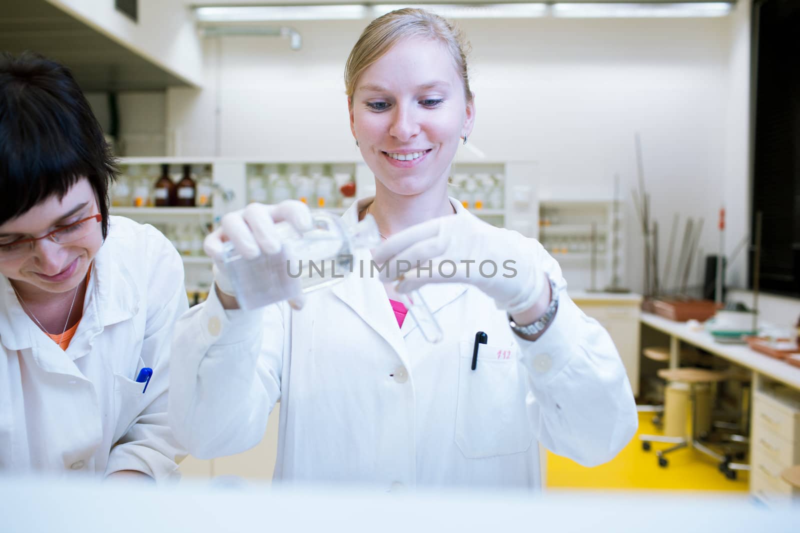 female researcher carrying out research in a chemical lab by viktor_cap