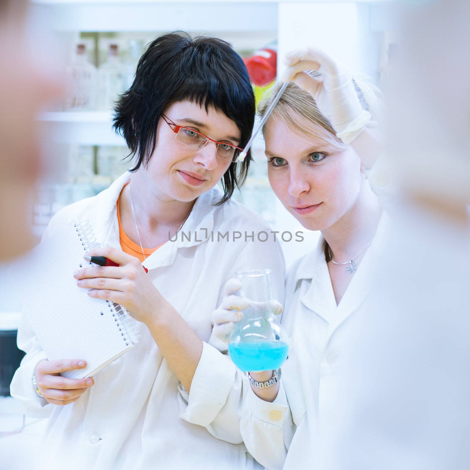 portrait of a female researcher carrying out research in a chemistry lab (color toned image; shallow DOF)