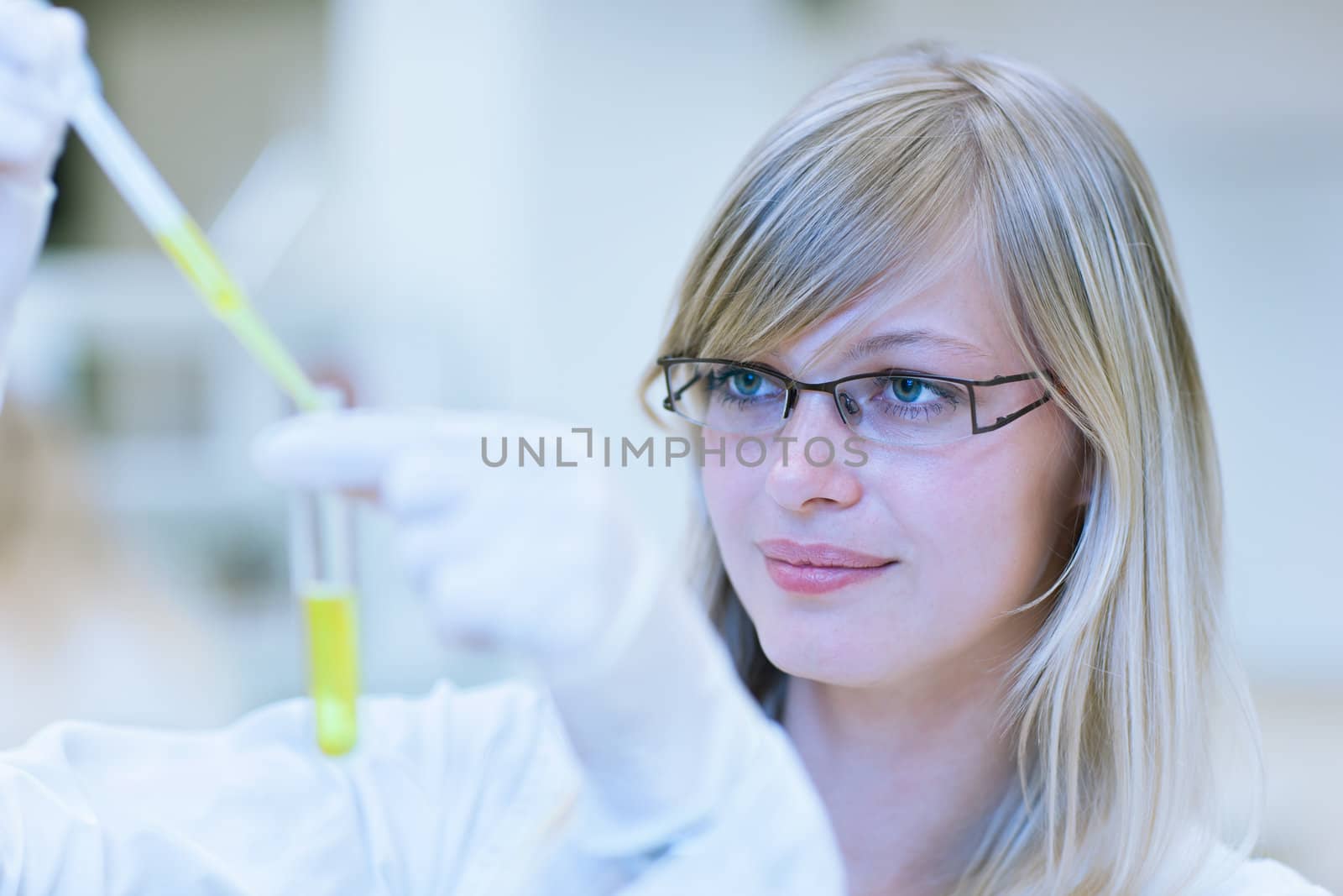 female researcher carrying out research in a chemistry lab by viktor_cap