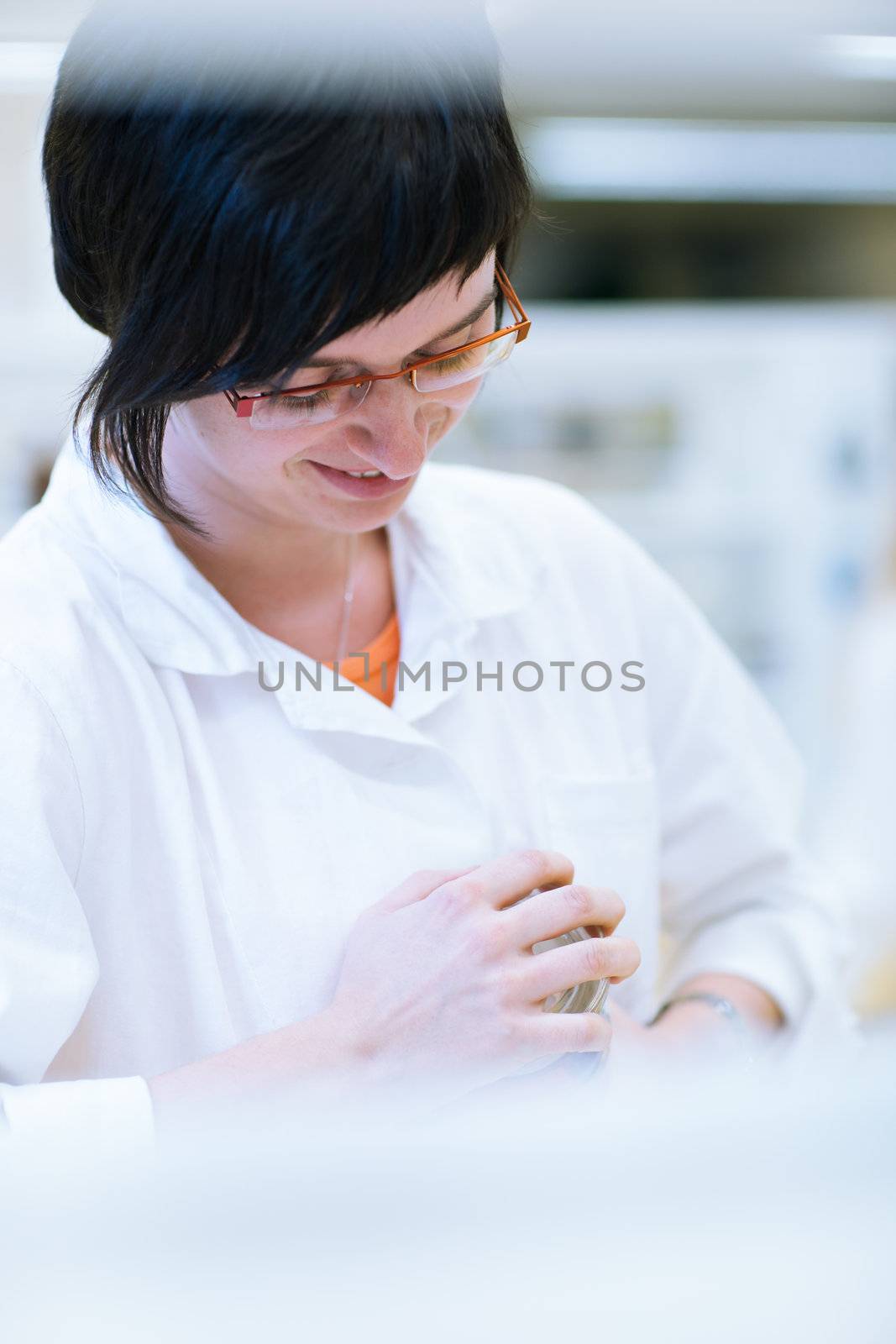 female researcher carrying out research in a chemistry lab by viktor_cap