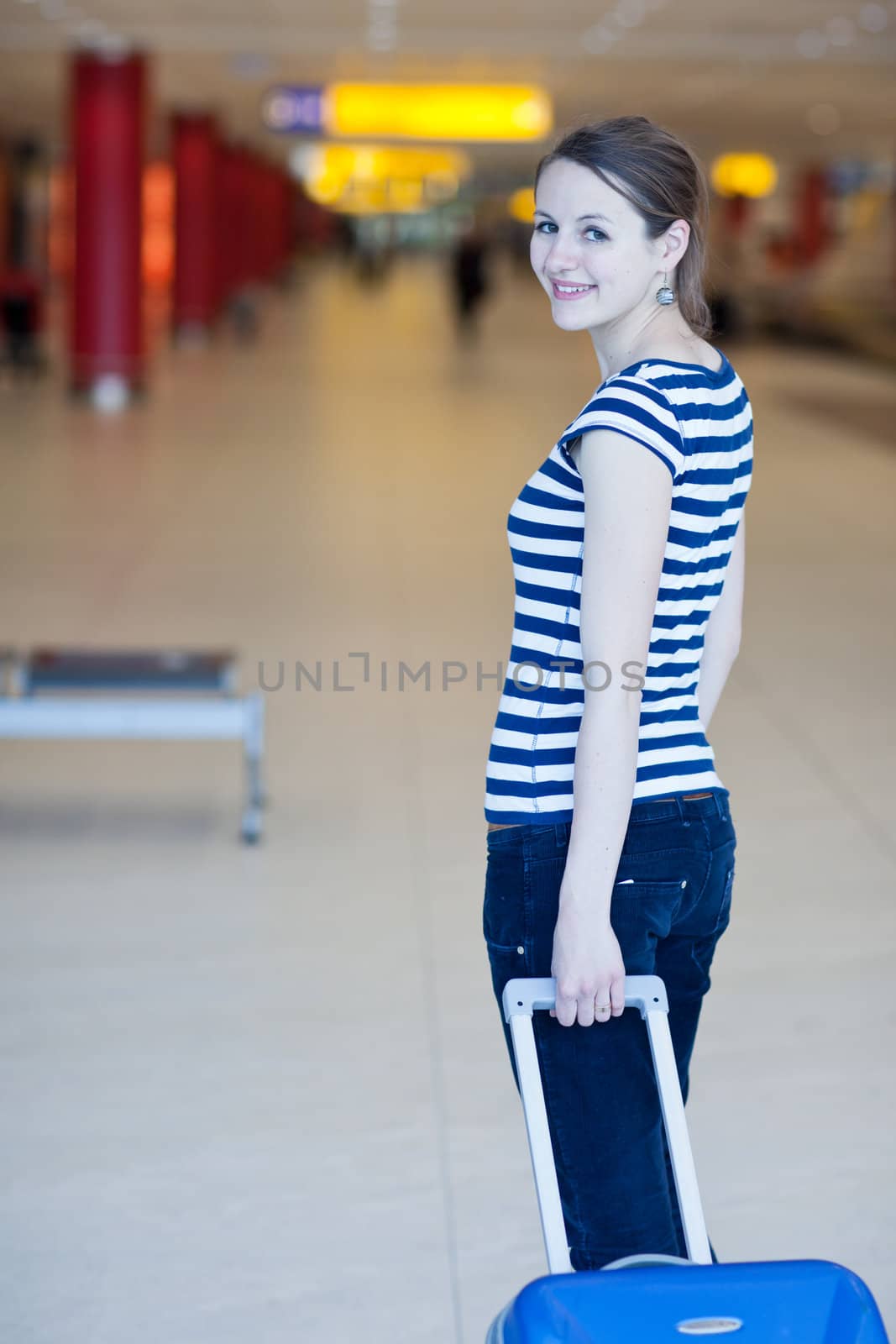Pretty young female passenger at the airport (shallow DOF; color toned image)
