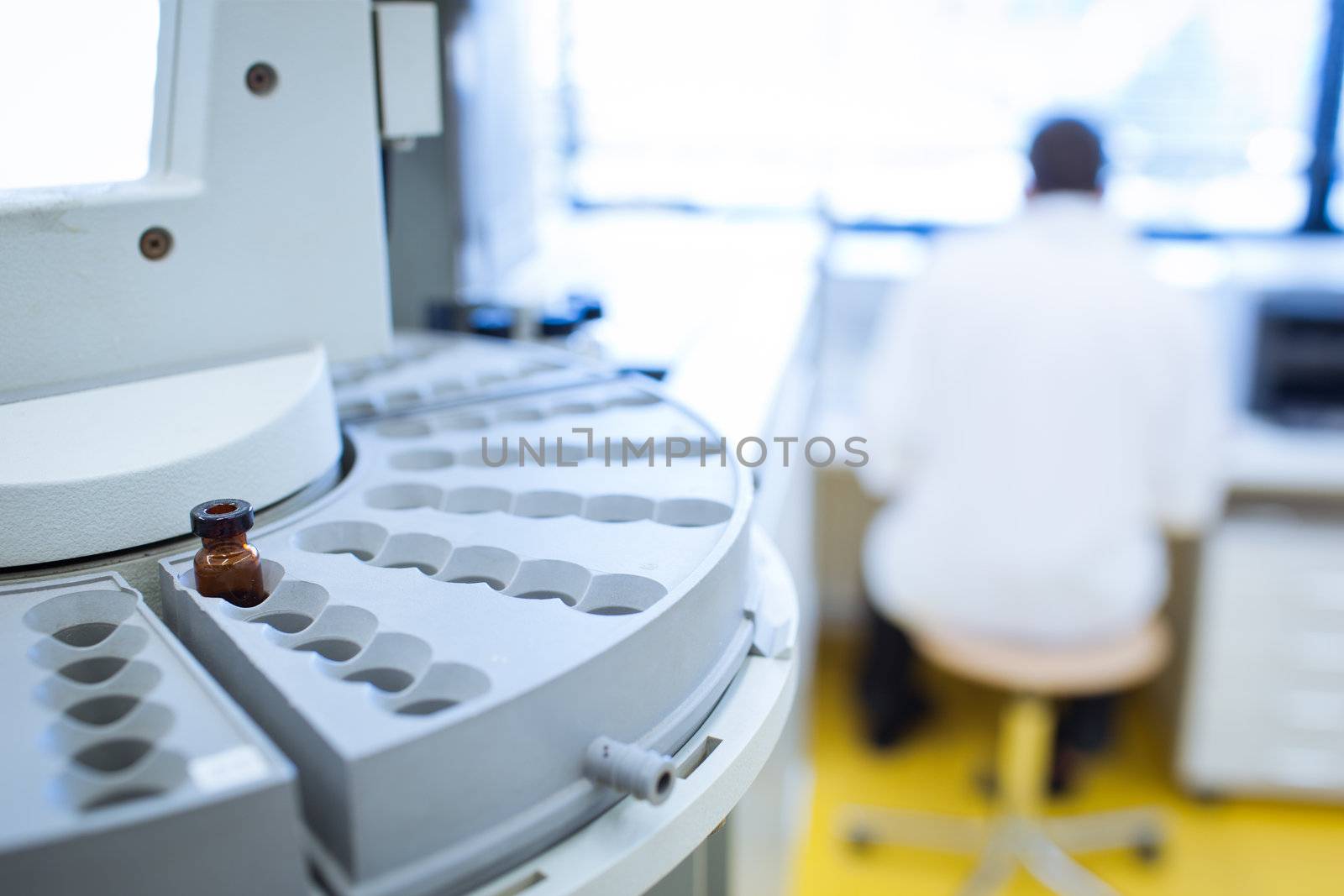 chemistry lab (shallow DOF; focus on the beakers in the foreground)