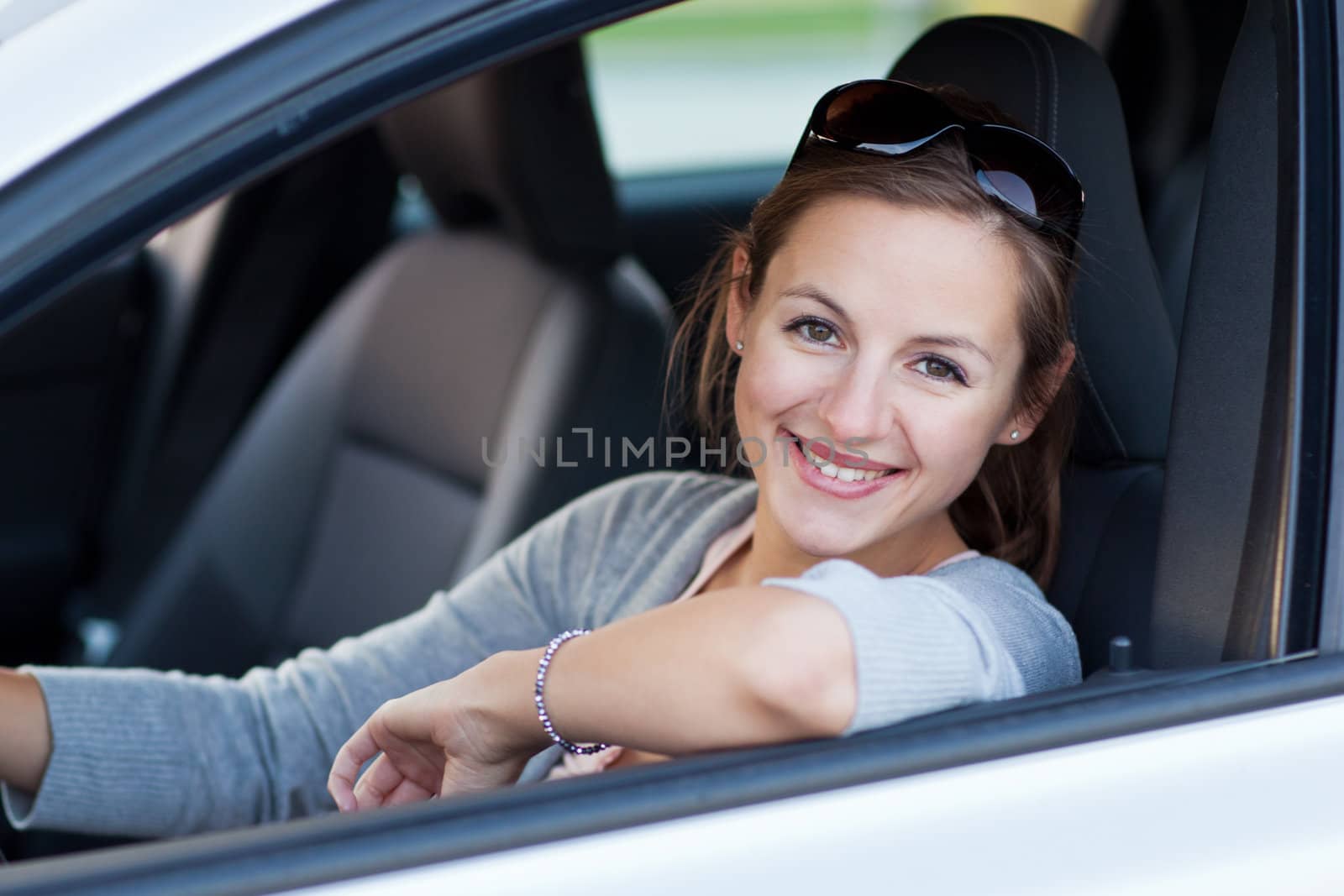 Pretty young woman driving her new car   by viktor_cap