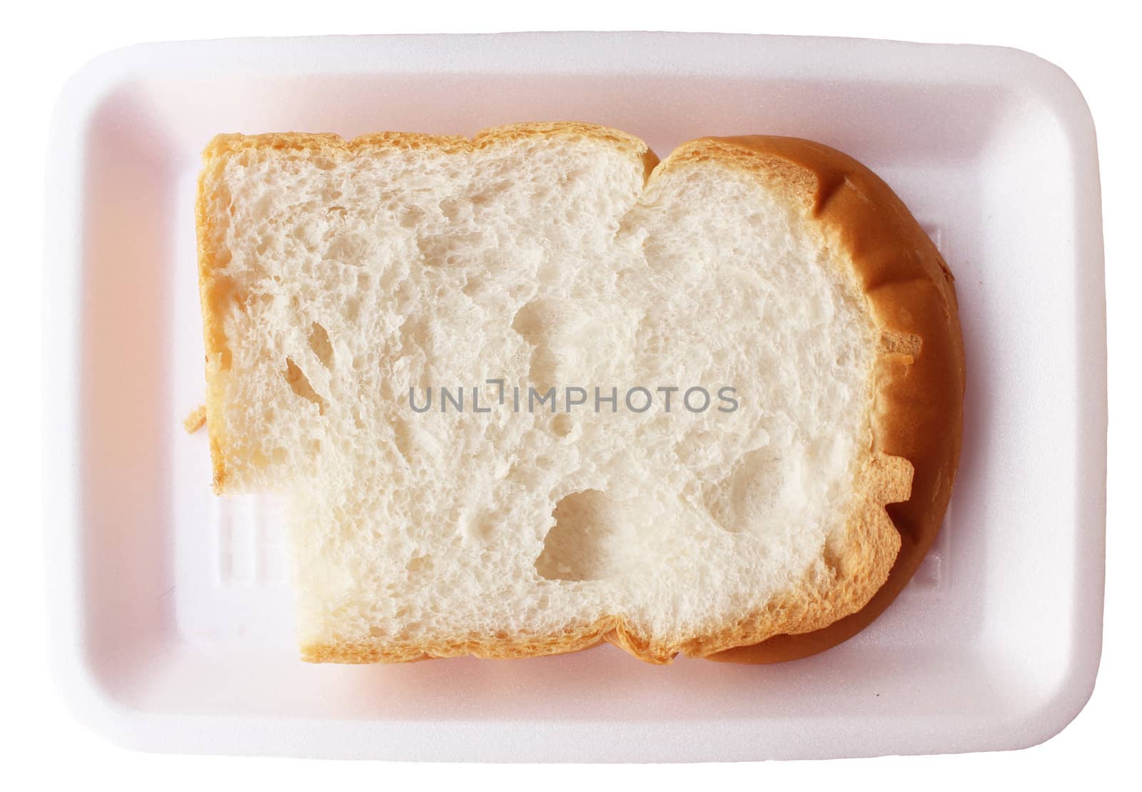 A single fresh slice of bitten white bread on plate
