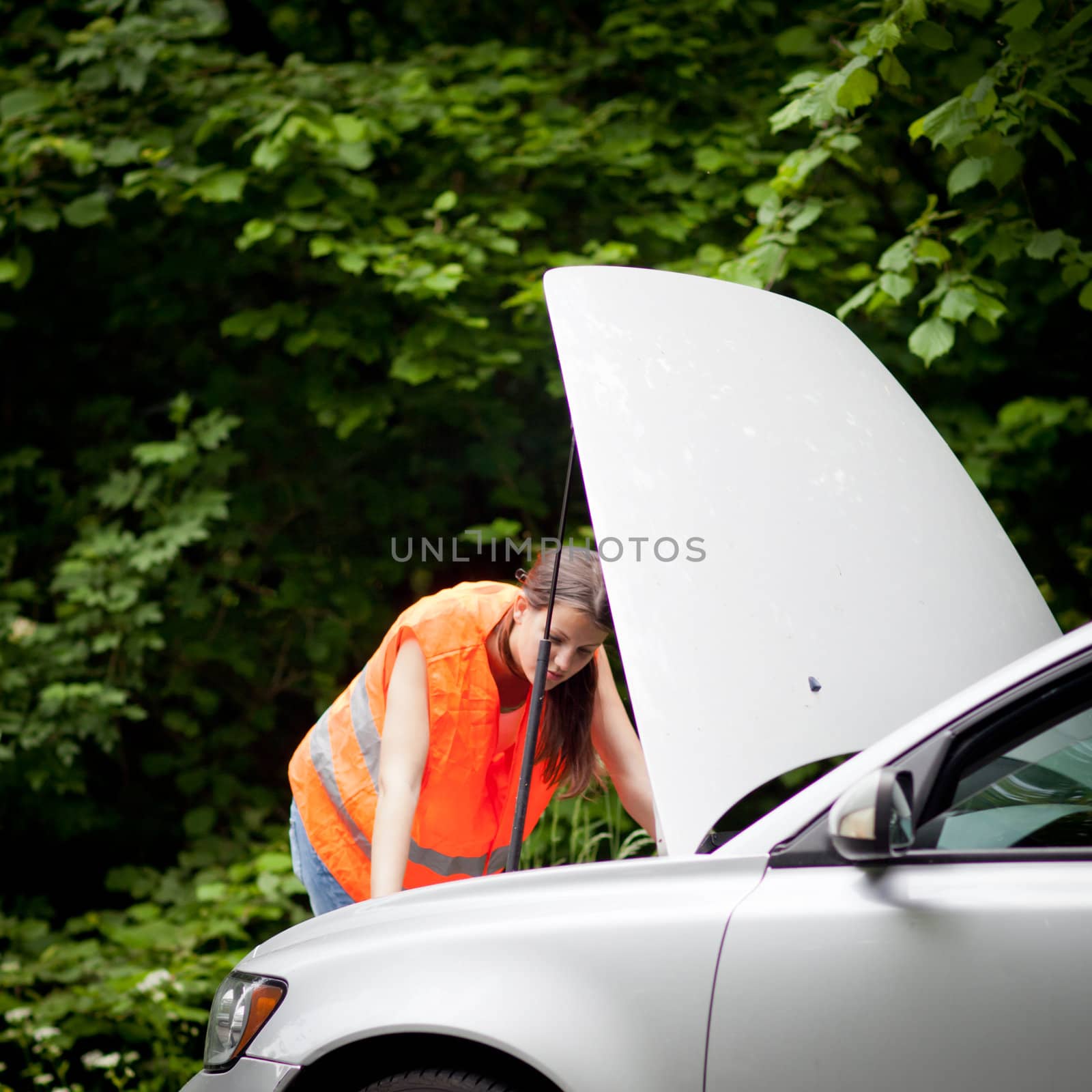 Young female driver wearing a high visibility vest, calling the by viktor_cap