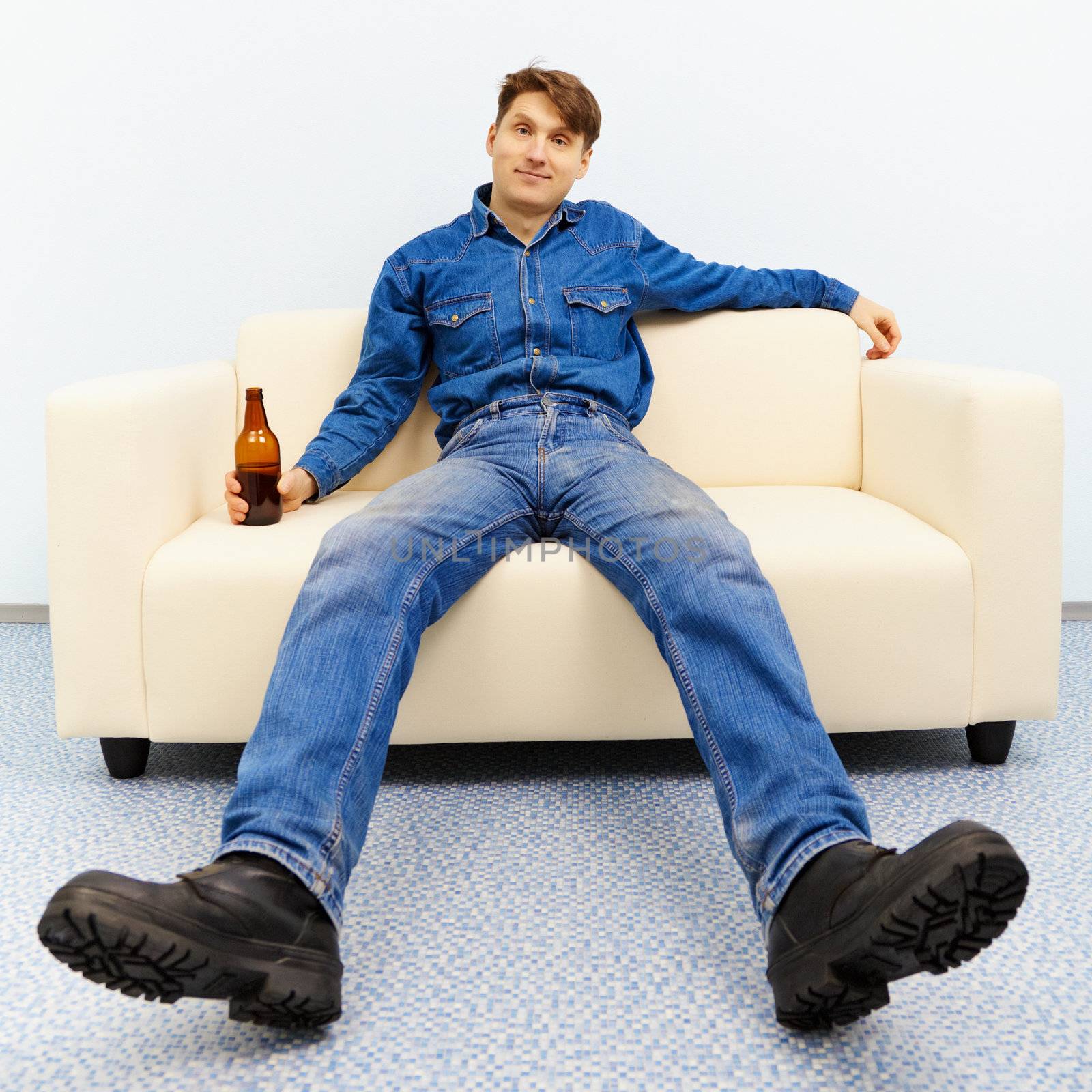 Normal inhabitant resting at home with a beer
