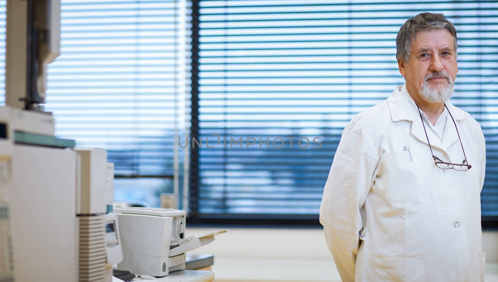 senior male researcher carrying out scientific research in a lab (shallow DOF; color toned image)