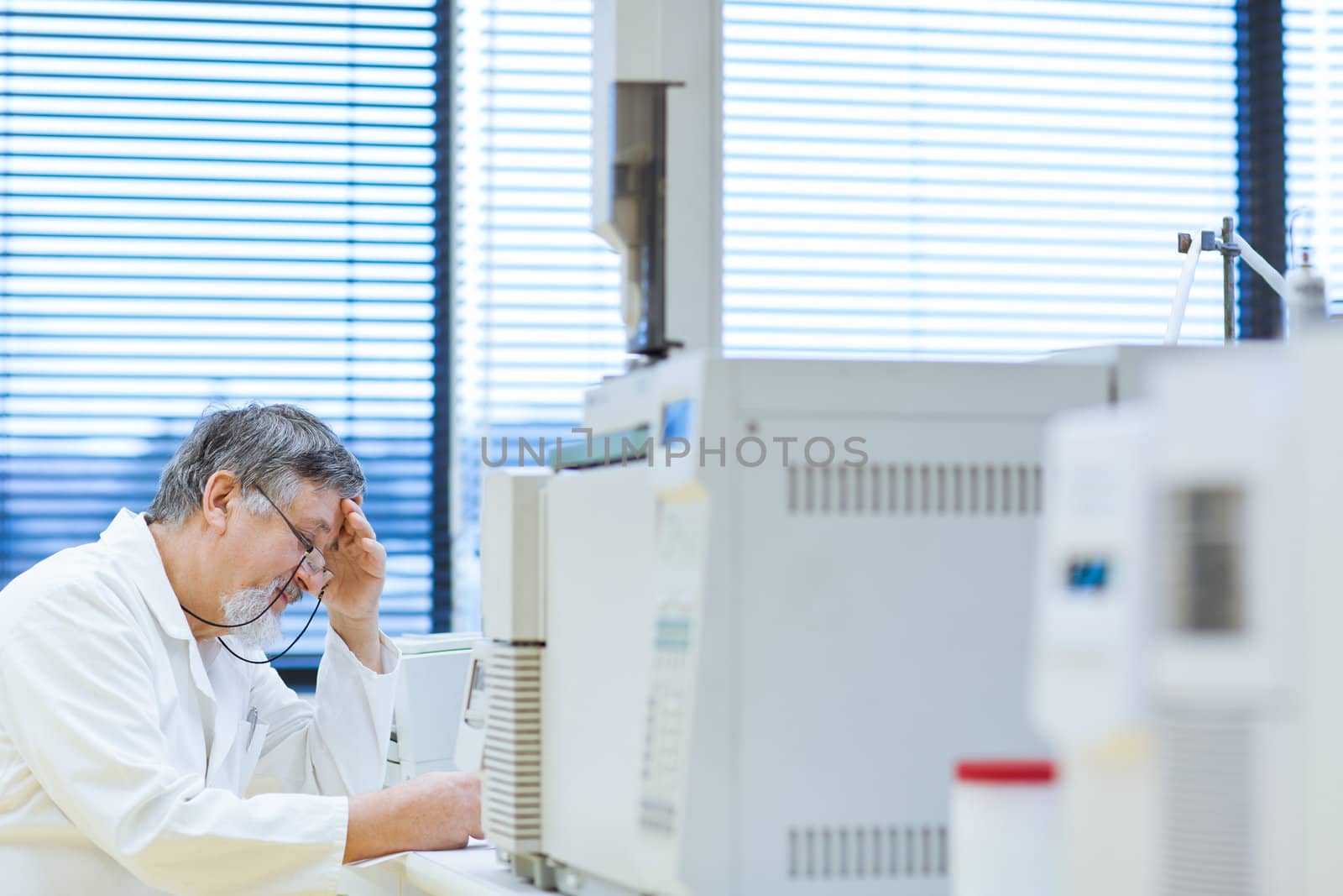 senior male researcher carrying out scientific research in a lab (shallow DOF; color toned image)