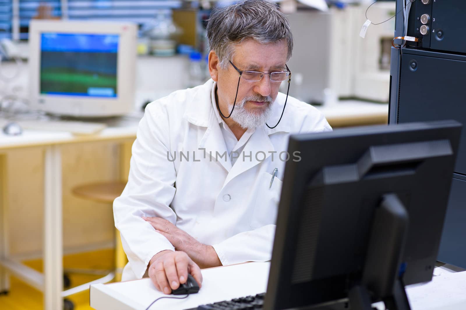 senior male researcher carrying out scientific research in a lab (shallow DOF; color toned image)