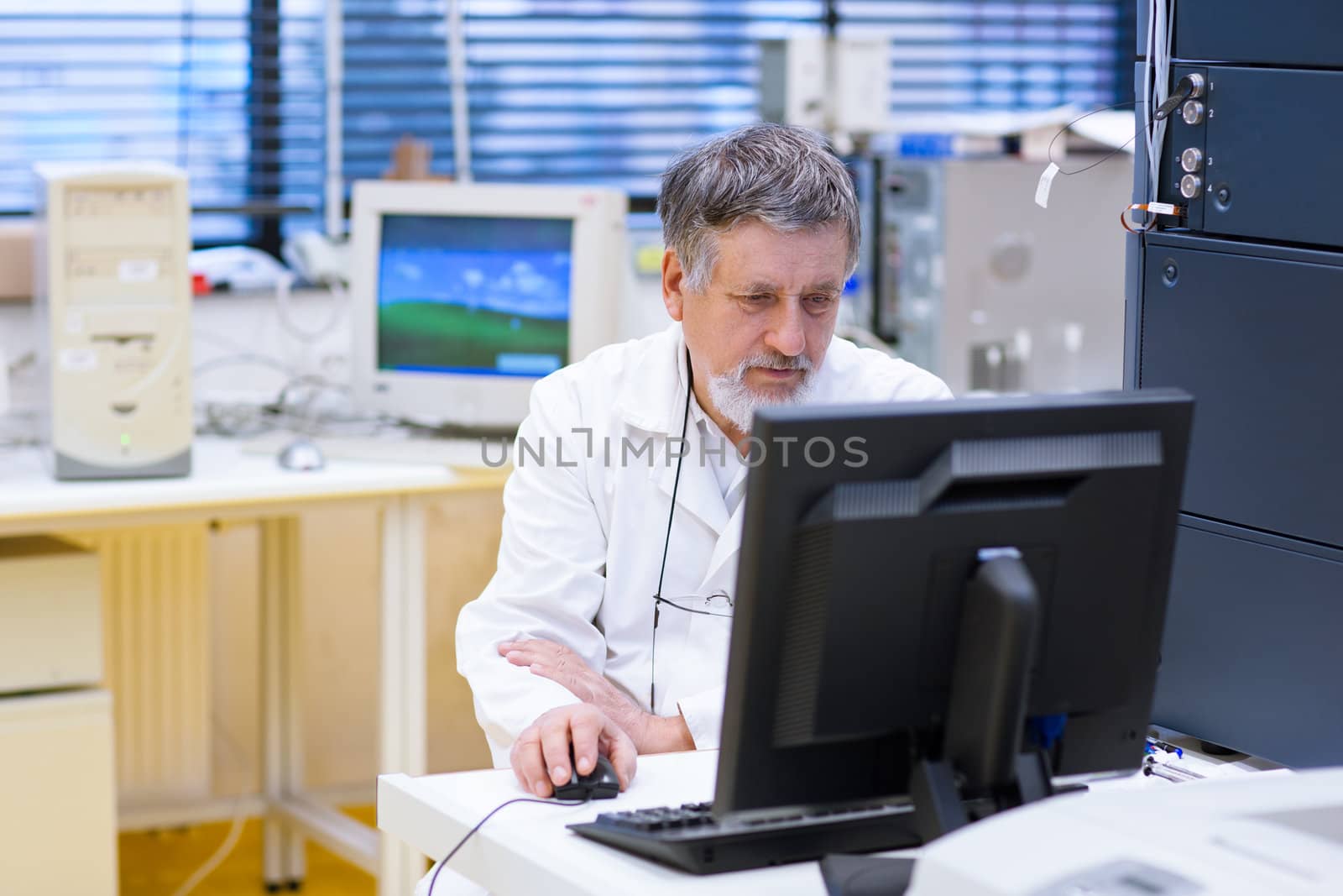 senior male researcher carrying out scientific research in a lab (shallow DOF; color toned image)