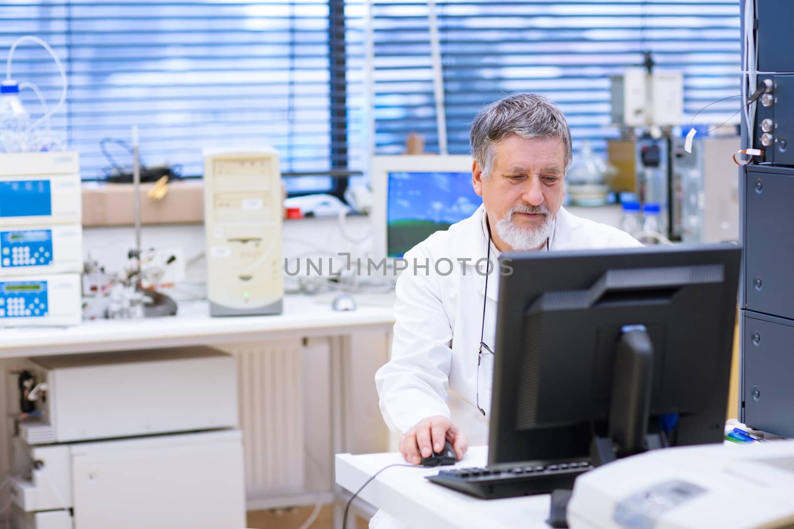 senior male researcher carrying out scientific research in a lab (shallow DOF; color toned image)