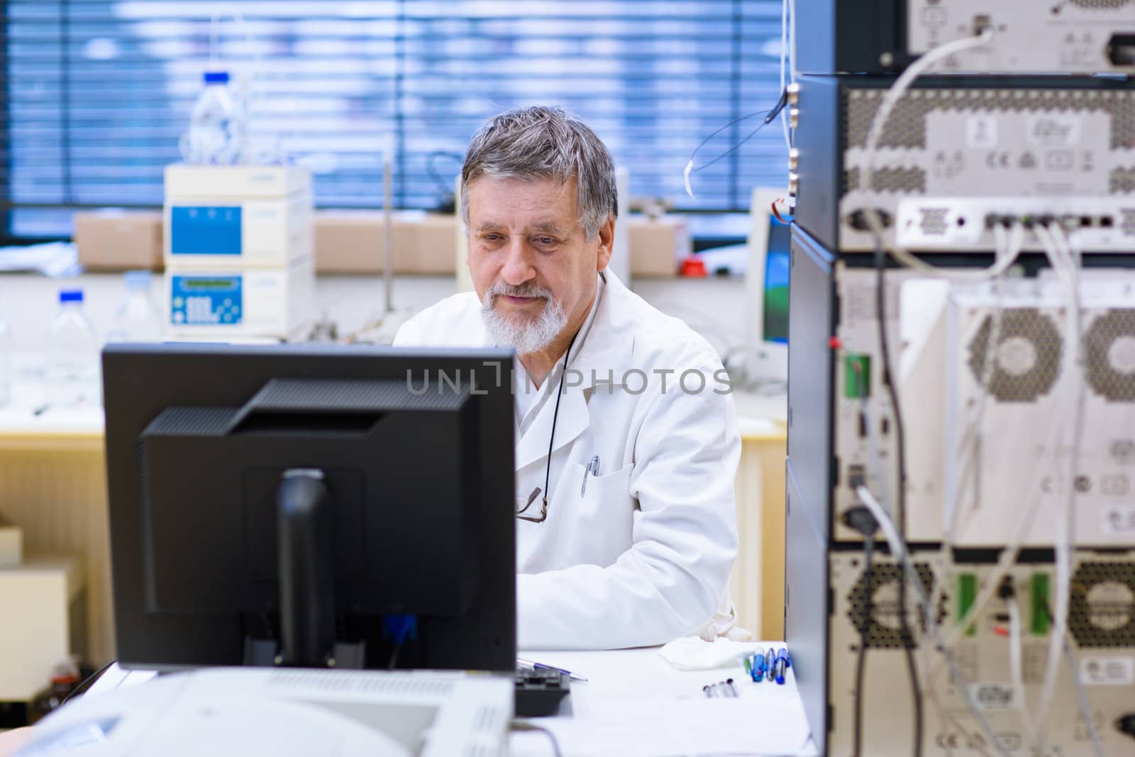 senior male researcher carrying out scientific research in a lab (shallow DOF; color toned image)