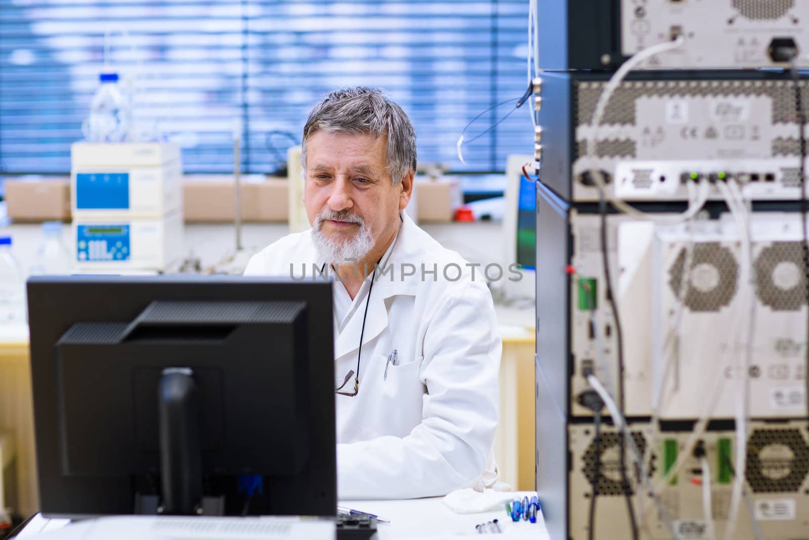 senior male researcher carrying out scientific research in a lab (shallow DOF; color toned image)