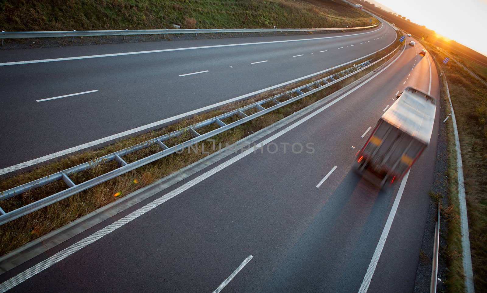 highway traffic - motion blurred truck on a highway/motorway/speedway at dusk (color toned image)