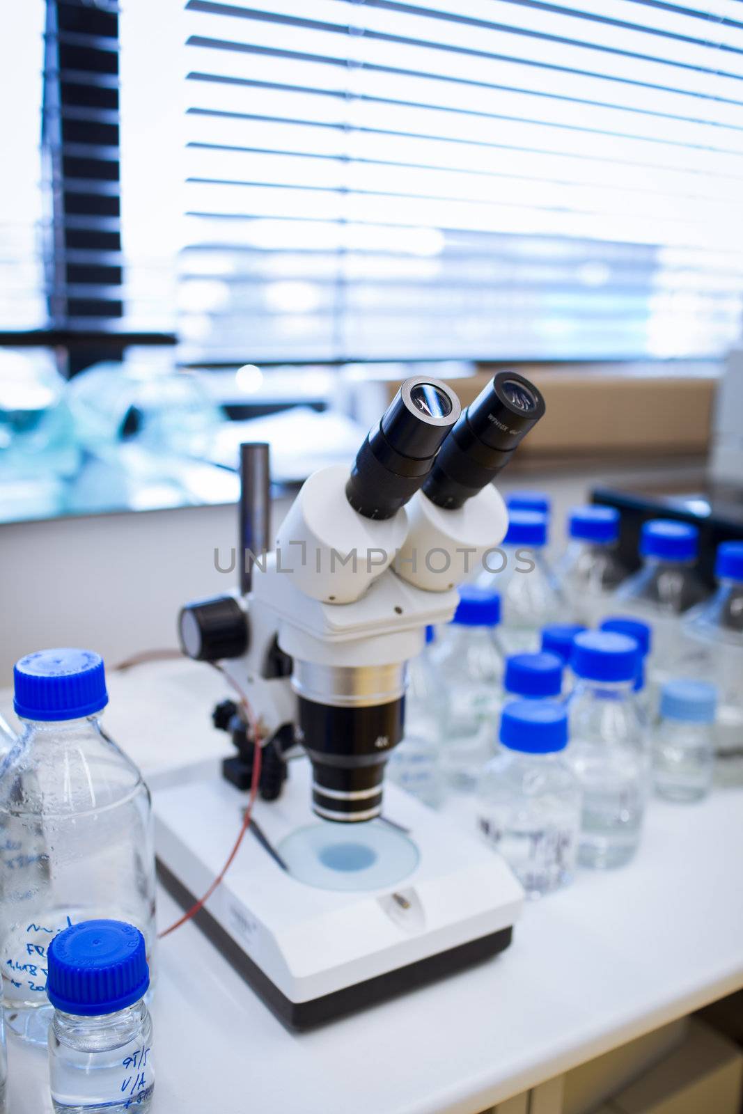 chemistry lab (shallow DOF; focus on the beakers in the foreground)