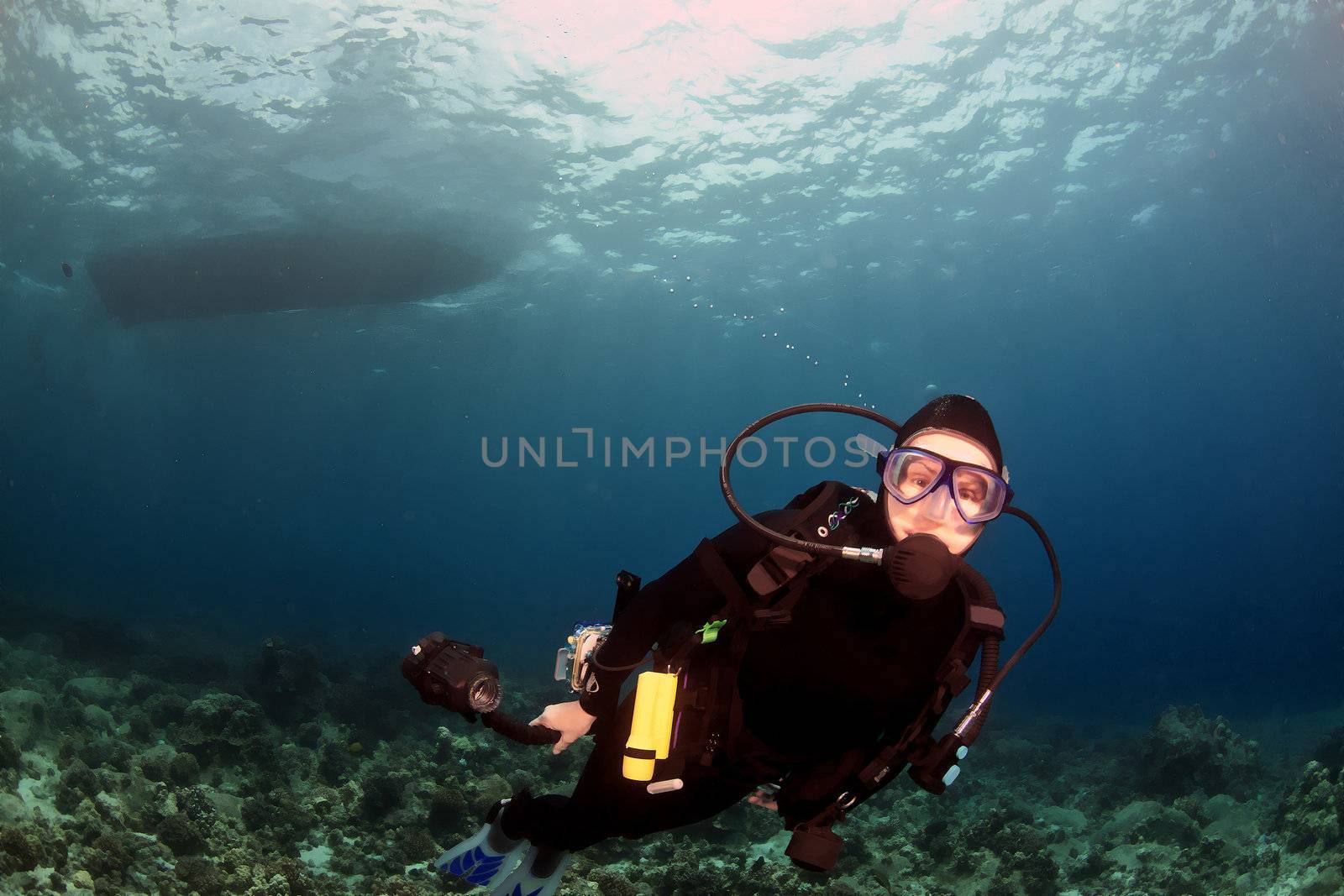 Diver swimming under the boat by KevinPanizza