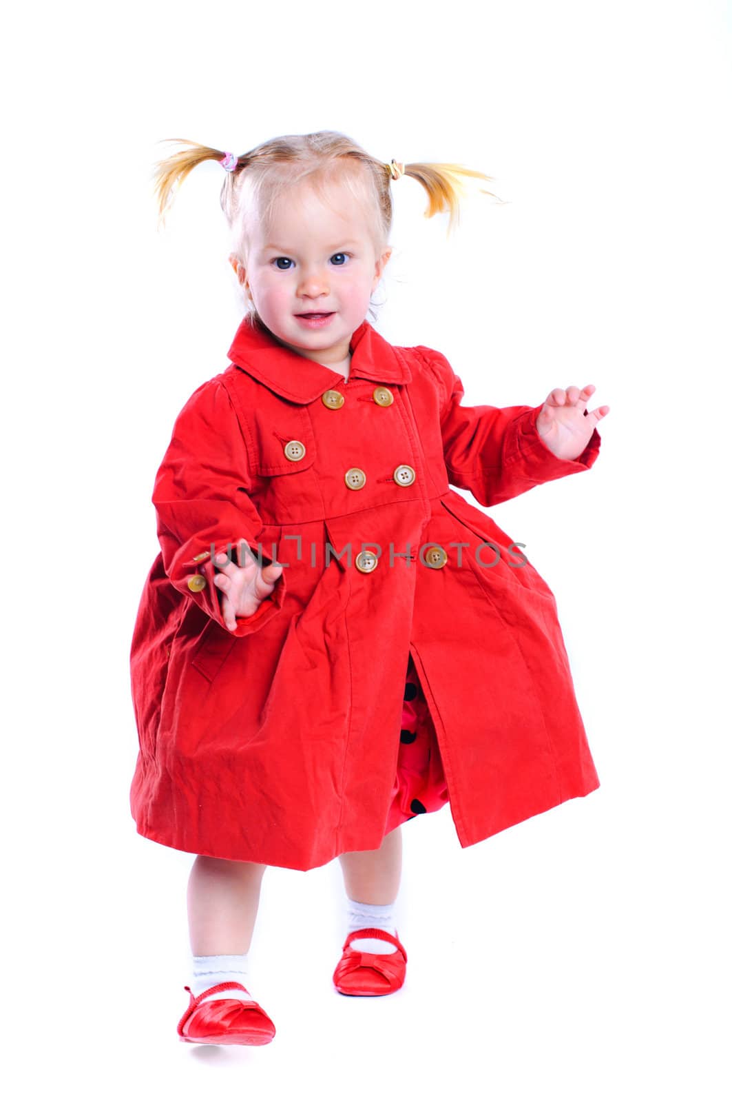 Cute little girl in a red dress. In the studio. Isolated by maxoliki