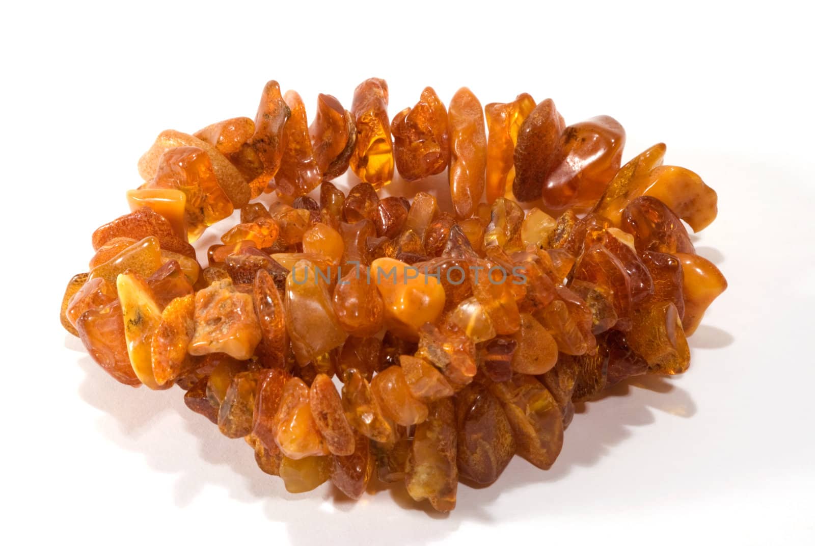 thread of amber bead on white background. close-up.
