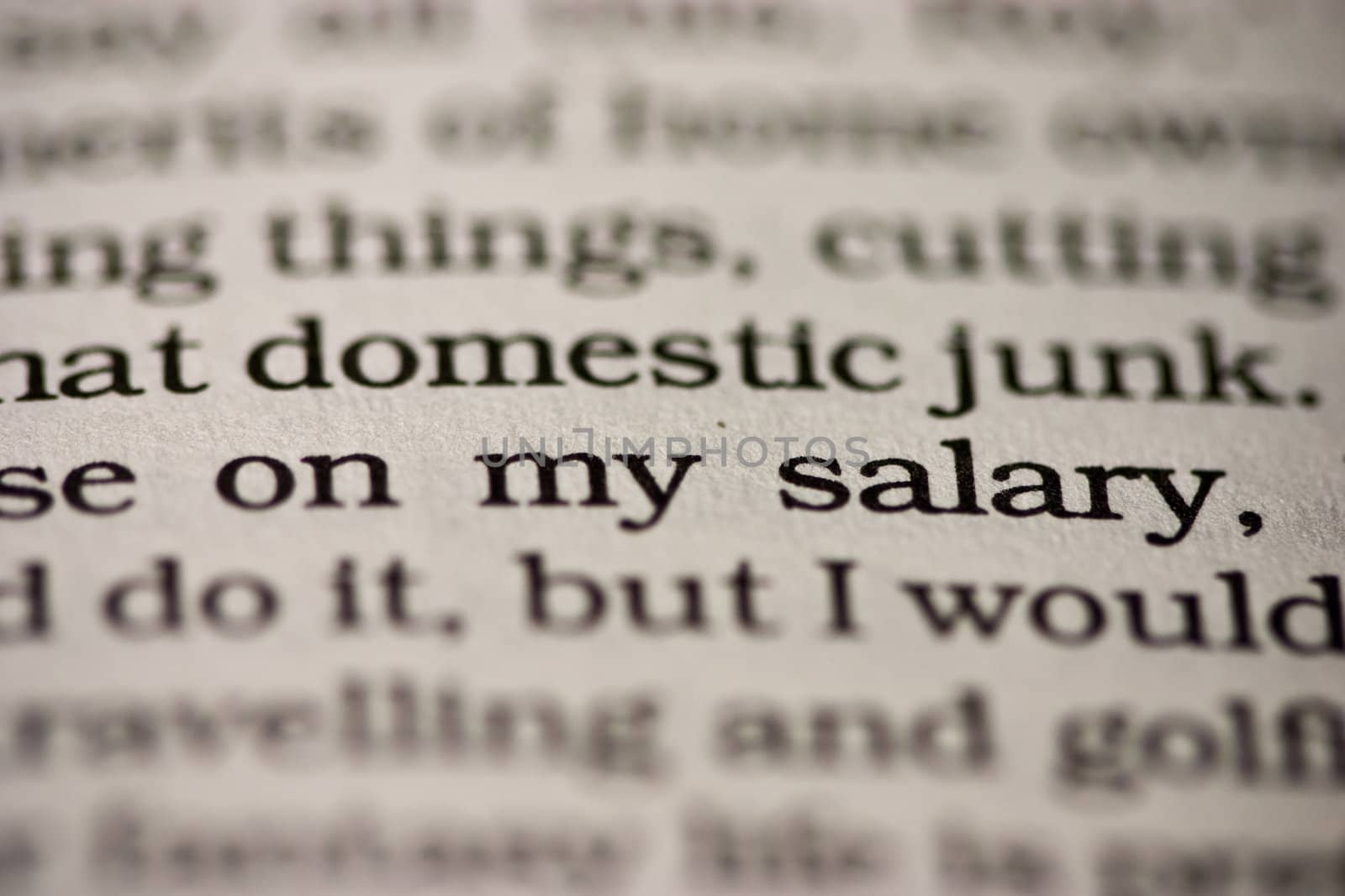 Close-up of the words in a book. Shallow depth-of-field cause rest of the text lines to blur