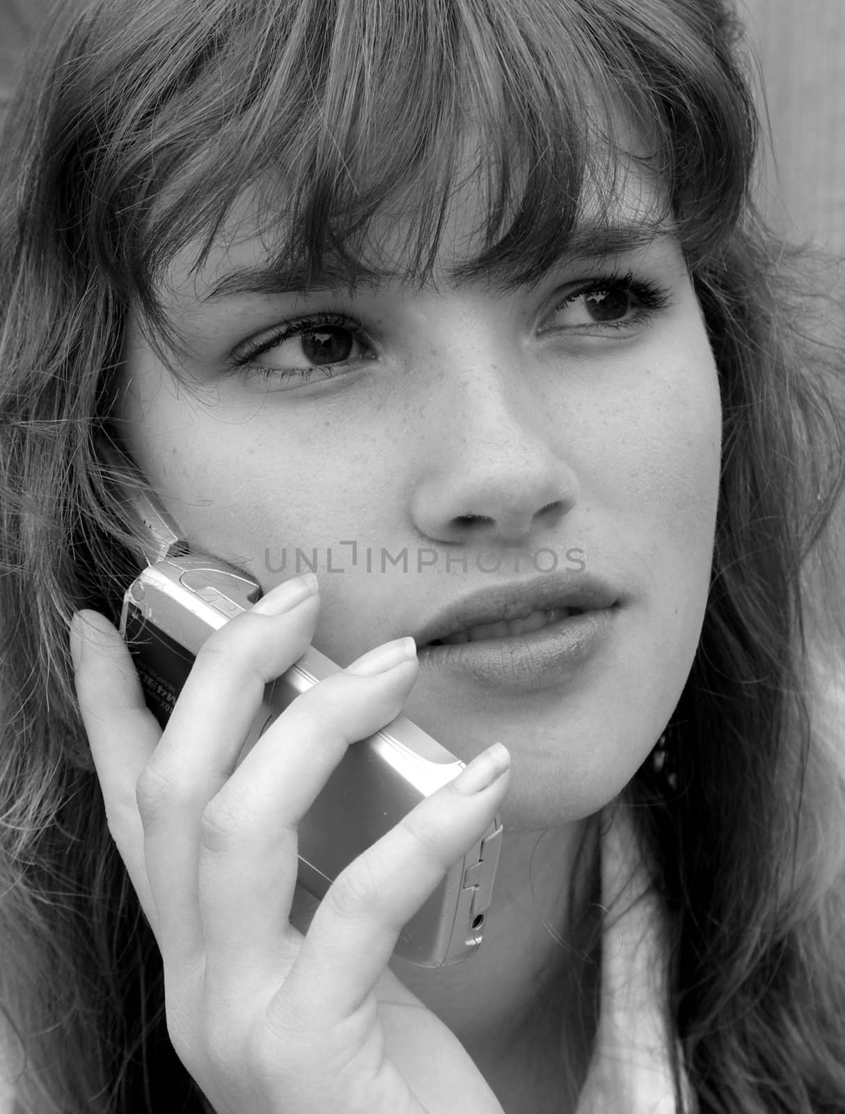 Portrait of a girl on the phone in black and white.
