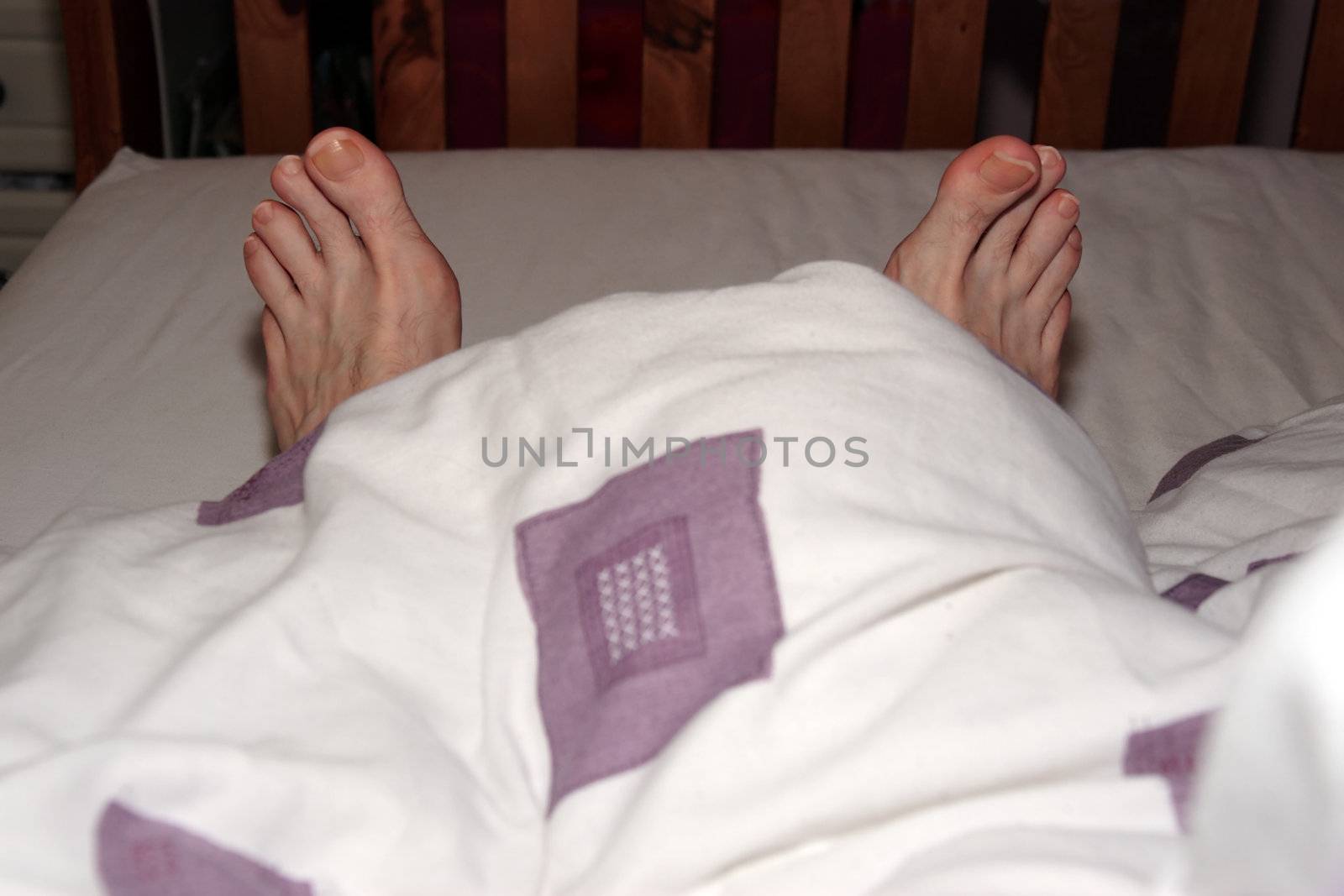 a view of a mans feet during a lazy lie in