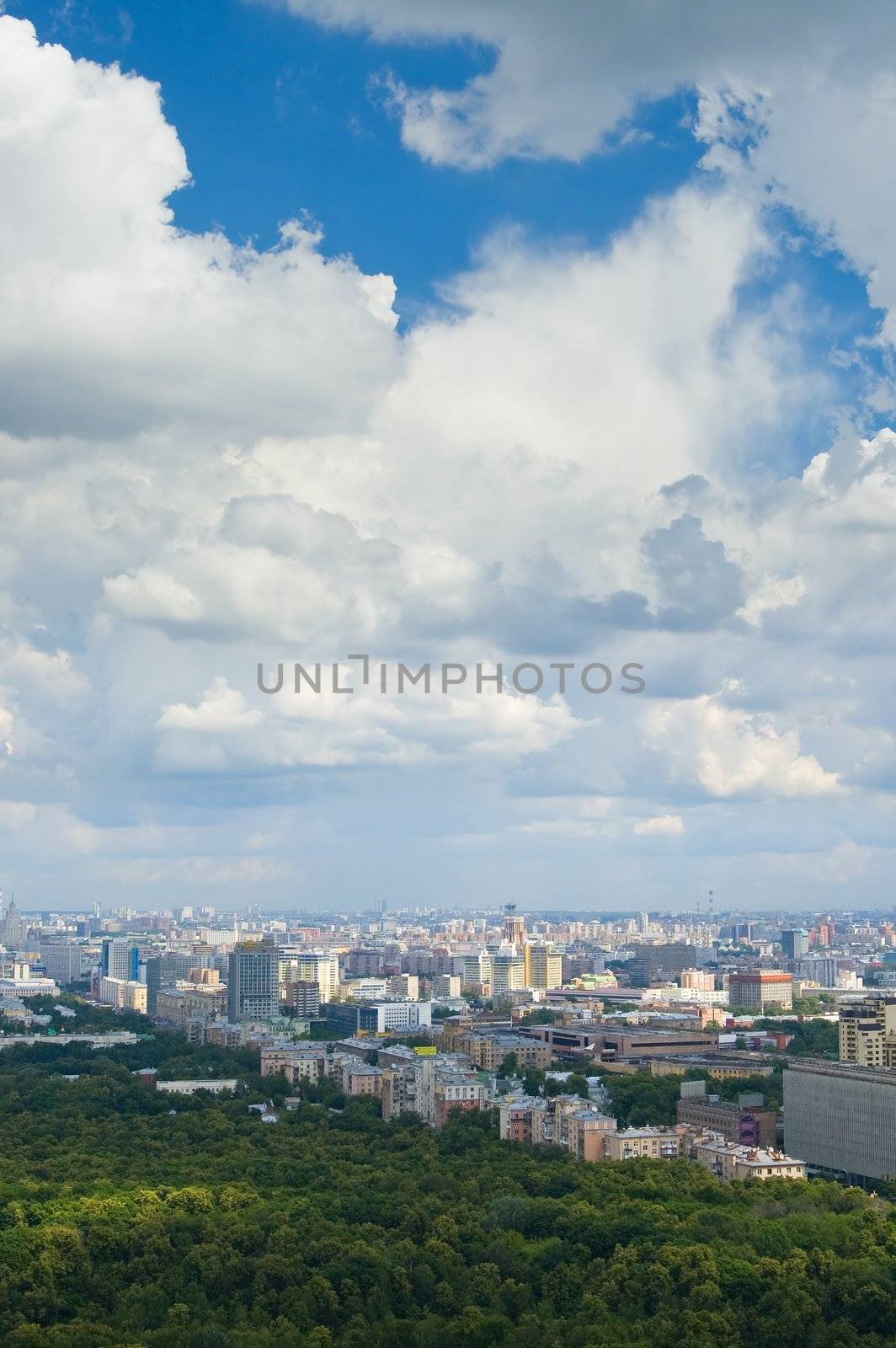 City and white clouds in a blue sky