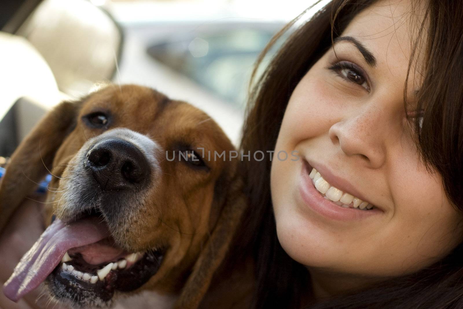 A portrait of a happy girl and her dog.