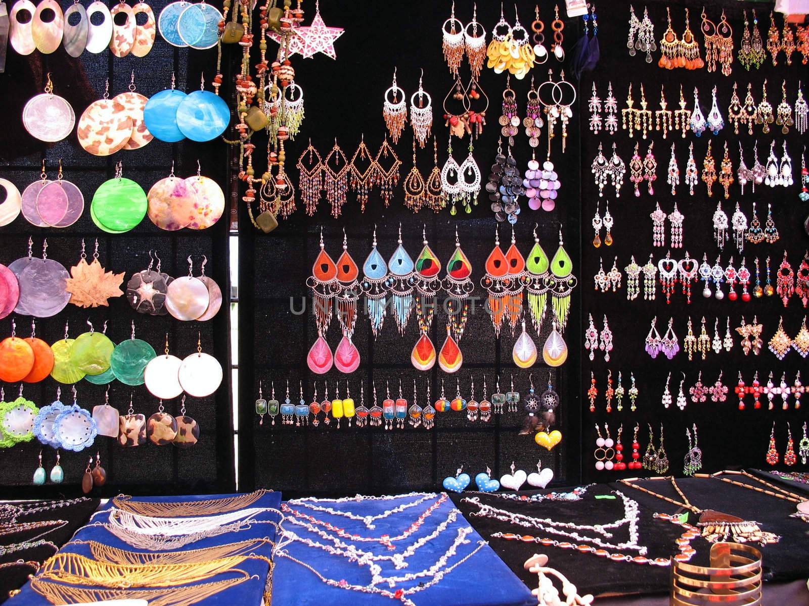 A very colorful assortment of jewelry on display.  Many of these are isolated nicely over black, and can be cut out very easily.