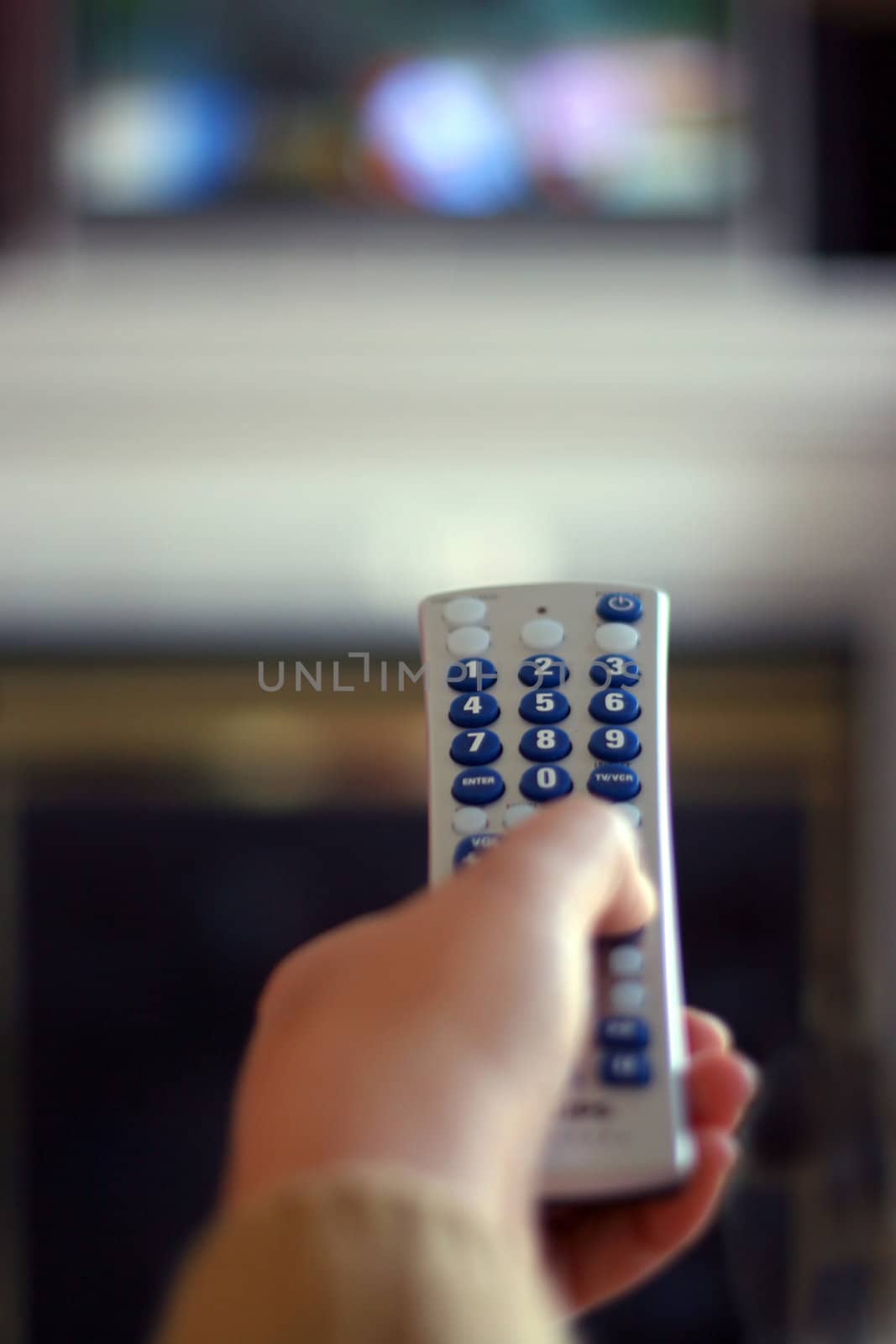 A remote control in action - shallow depth of field, with focus on the remote.