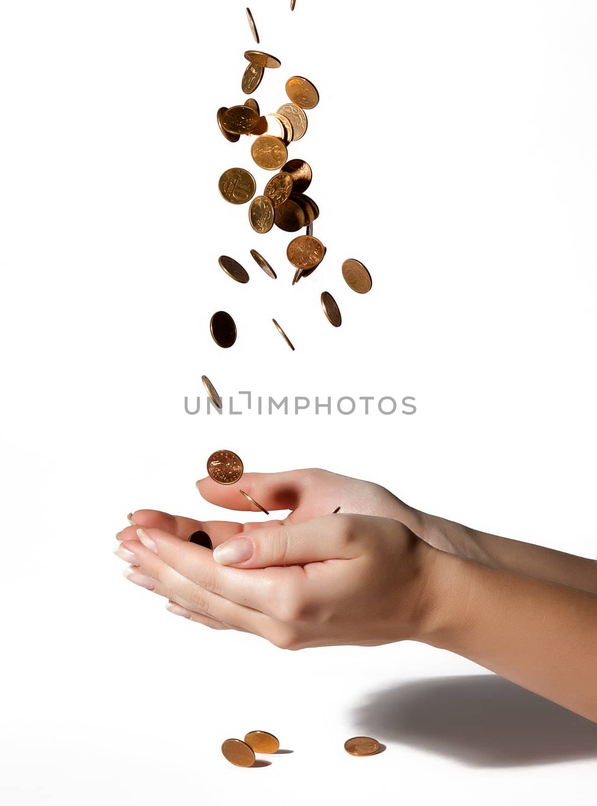 coins fall into his hands on white background