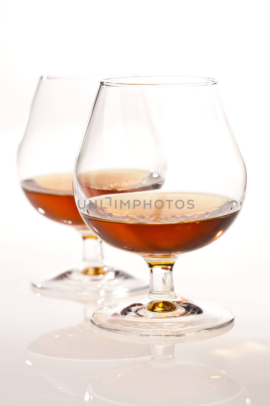 glass of tasty brandy on white