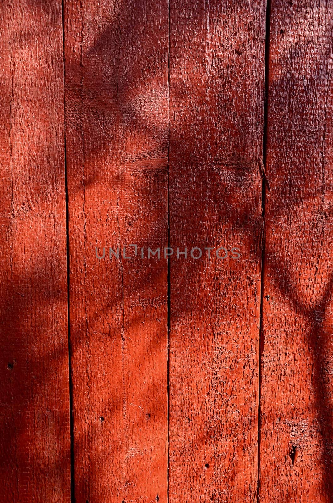 Shadows on red-painted wooden wall. by sauletas