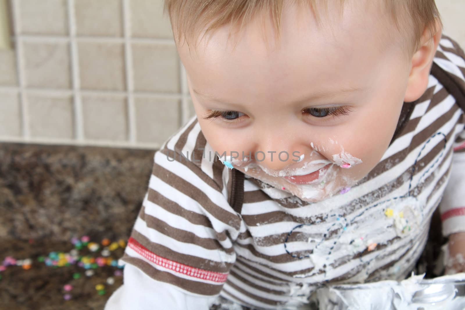 Laughing Baby boy covered in icing sugar