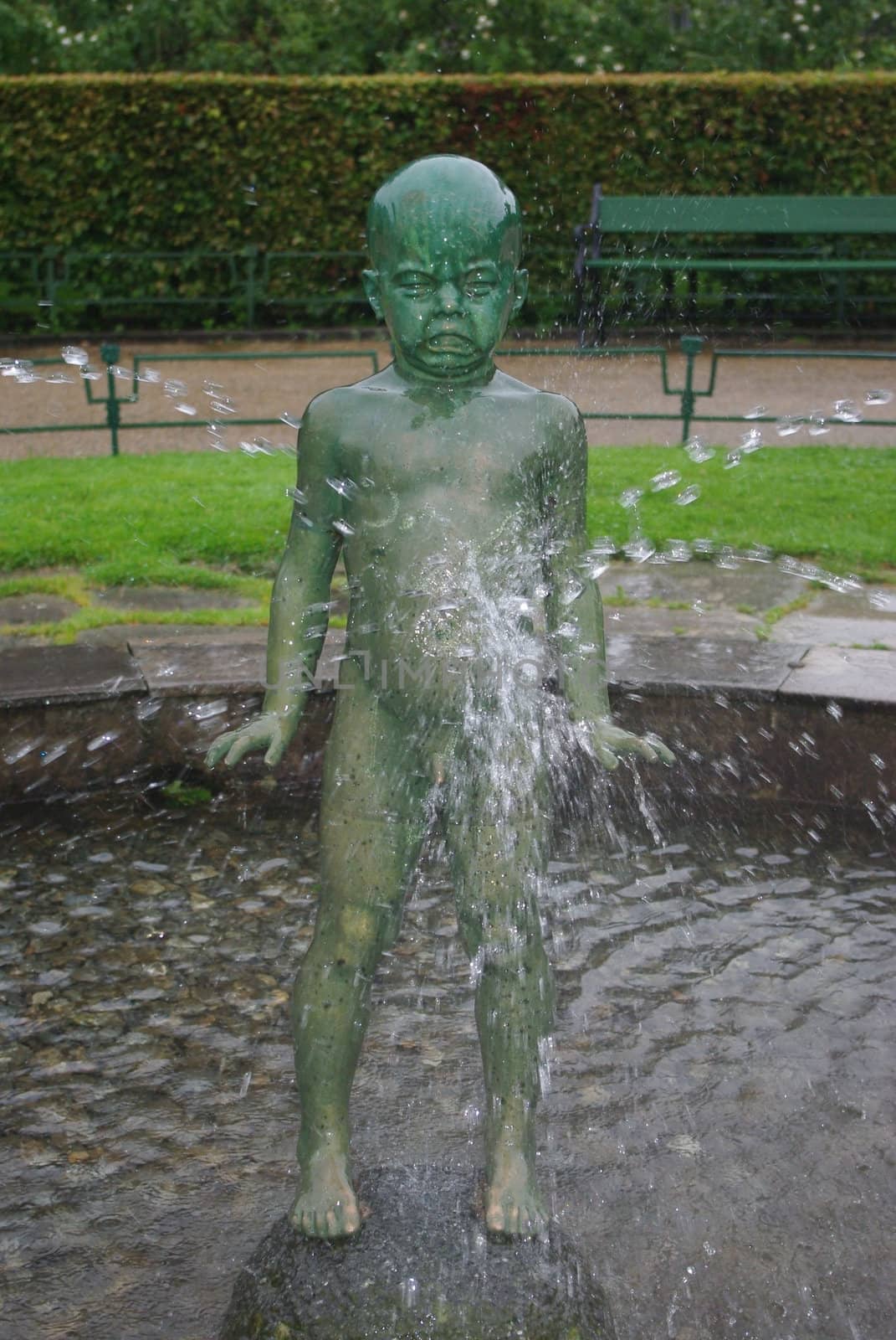 Statue of crying boy in fontain by Vitamin