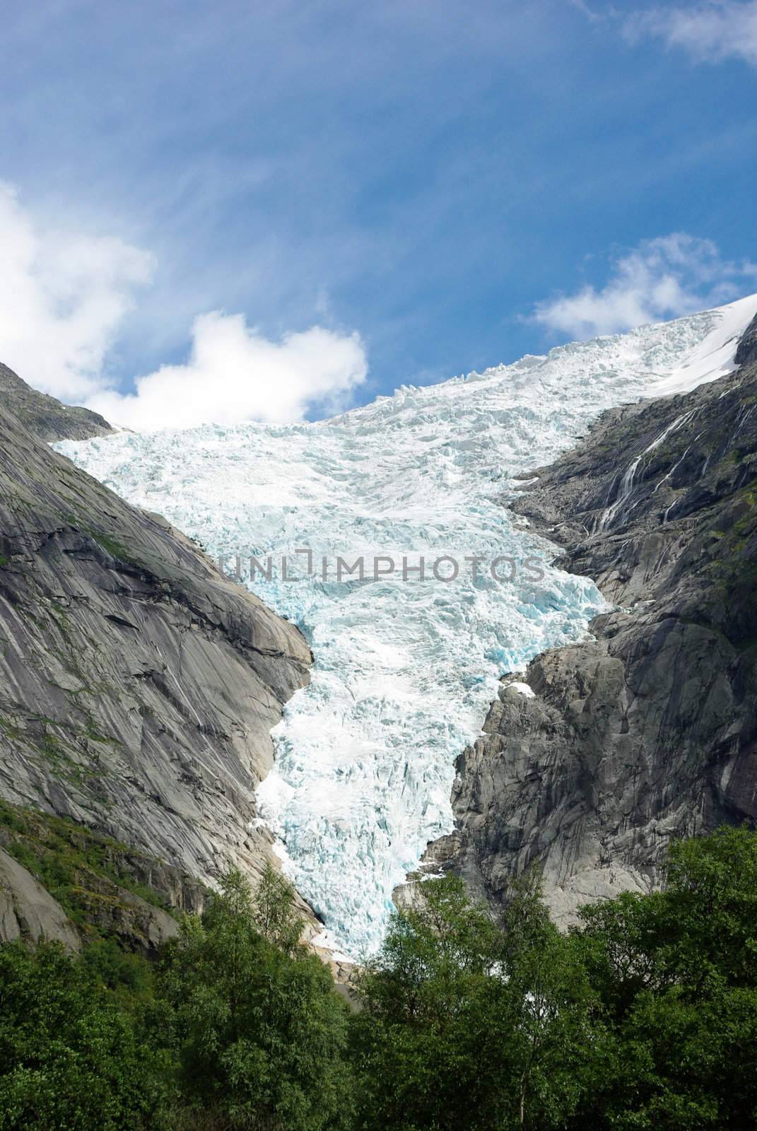 Mountain river flowing from glacier Briksdale in Norway, Europe