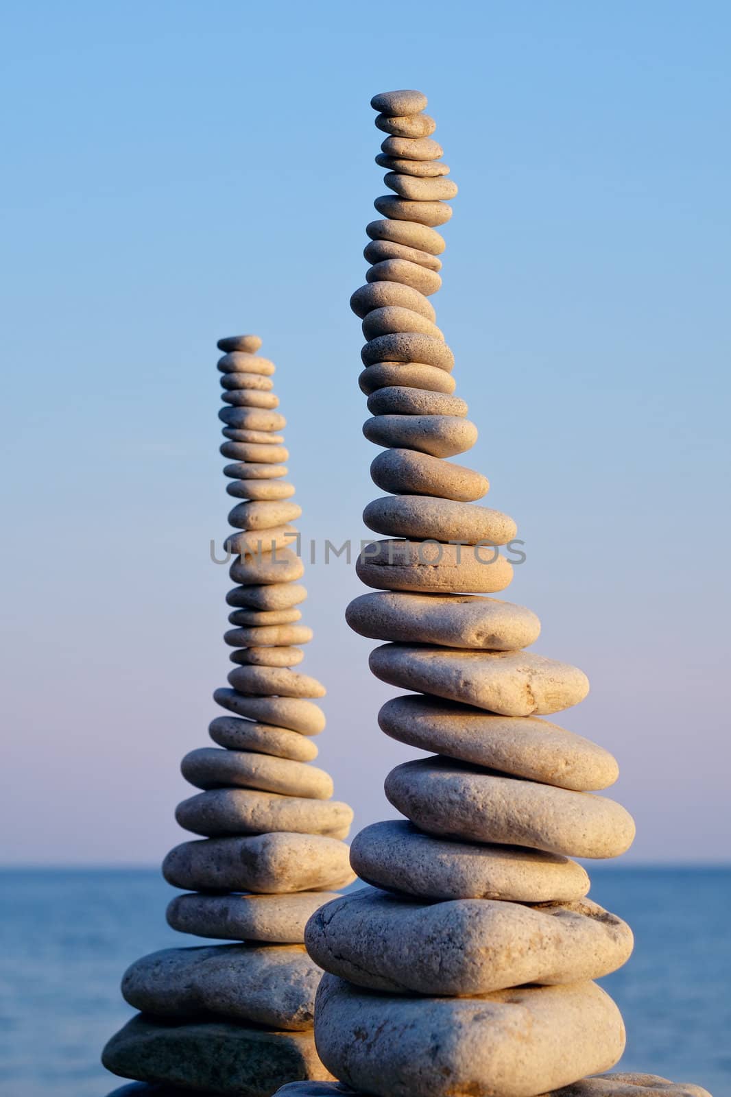 Two pile of pebbles in the balance on the seacoast