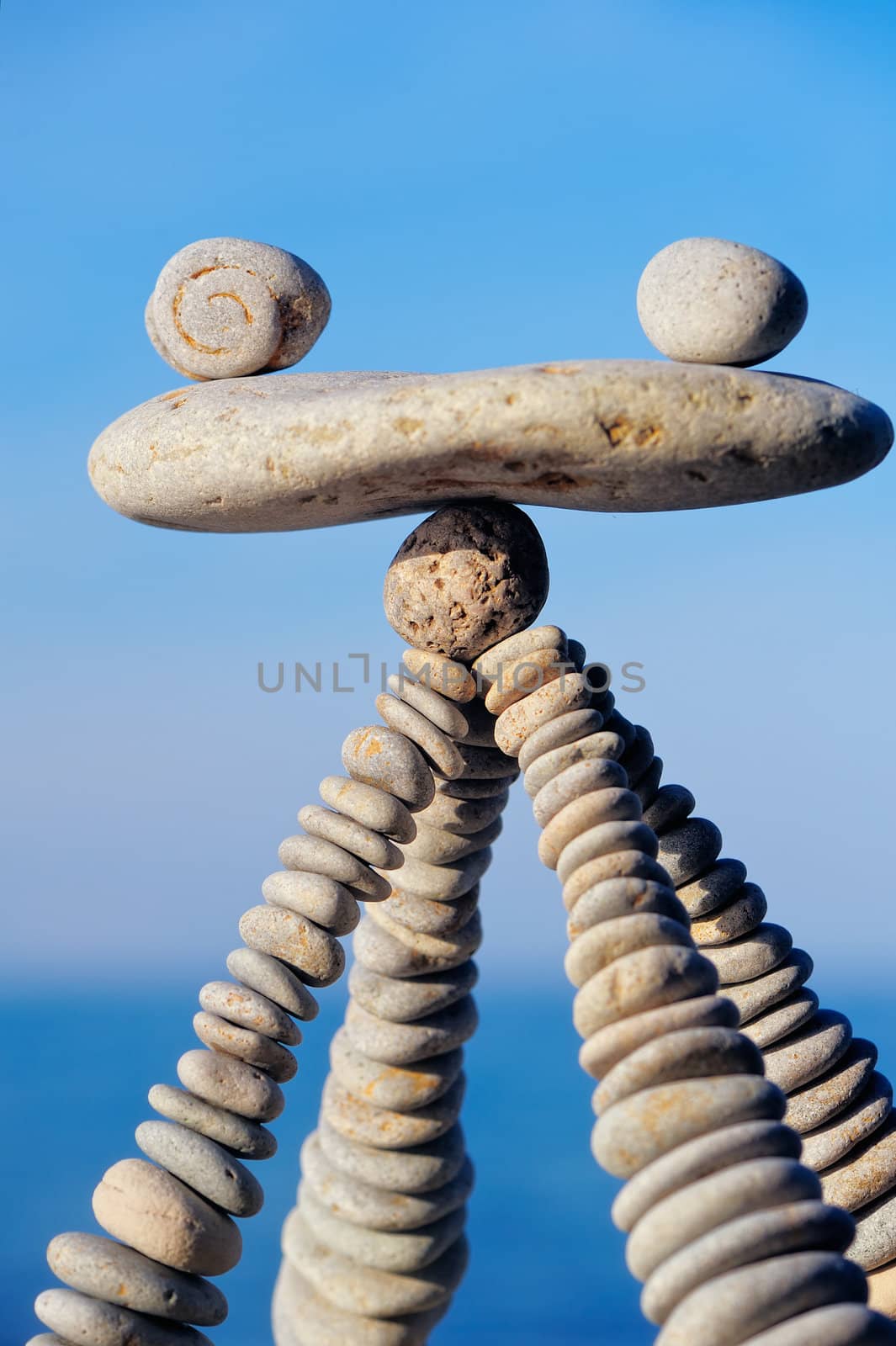 Balancing of white pebbles on the top of piles