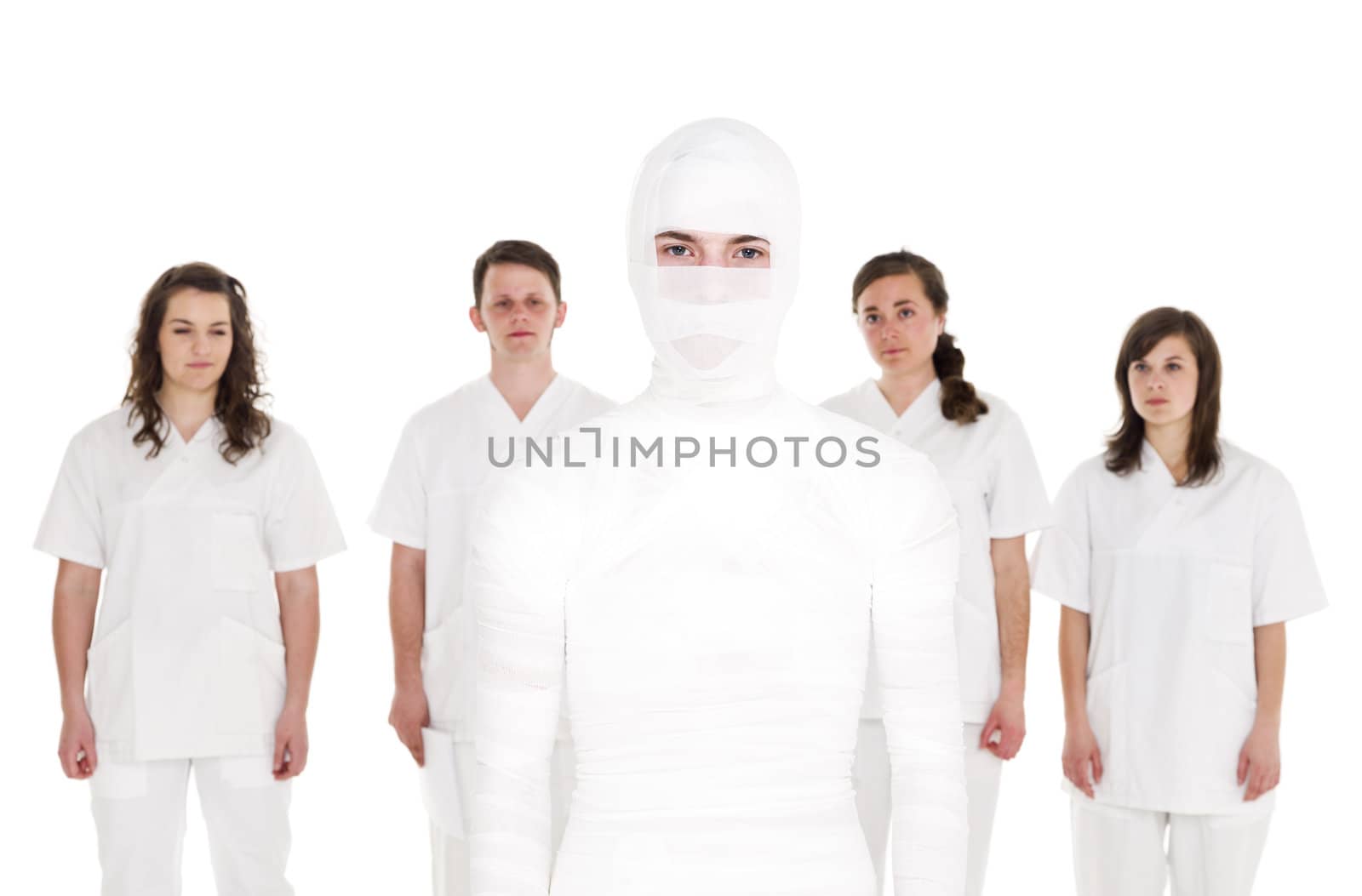 Mummyfied Patient in front of Healtcare Staff isolated on white background