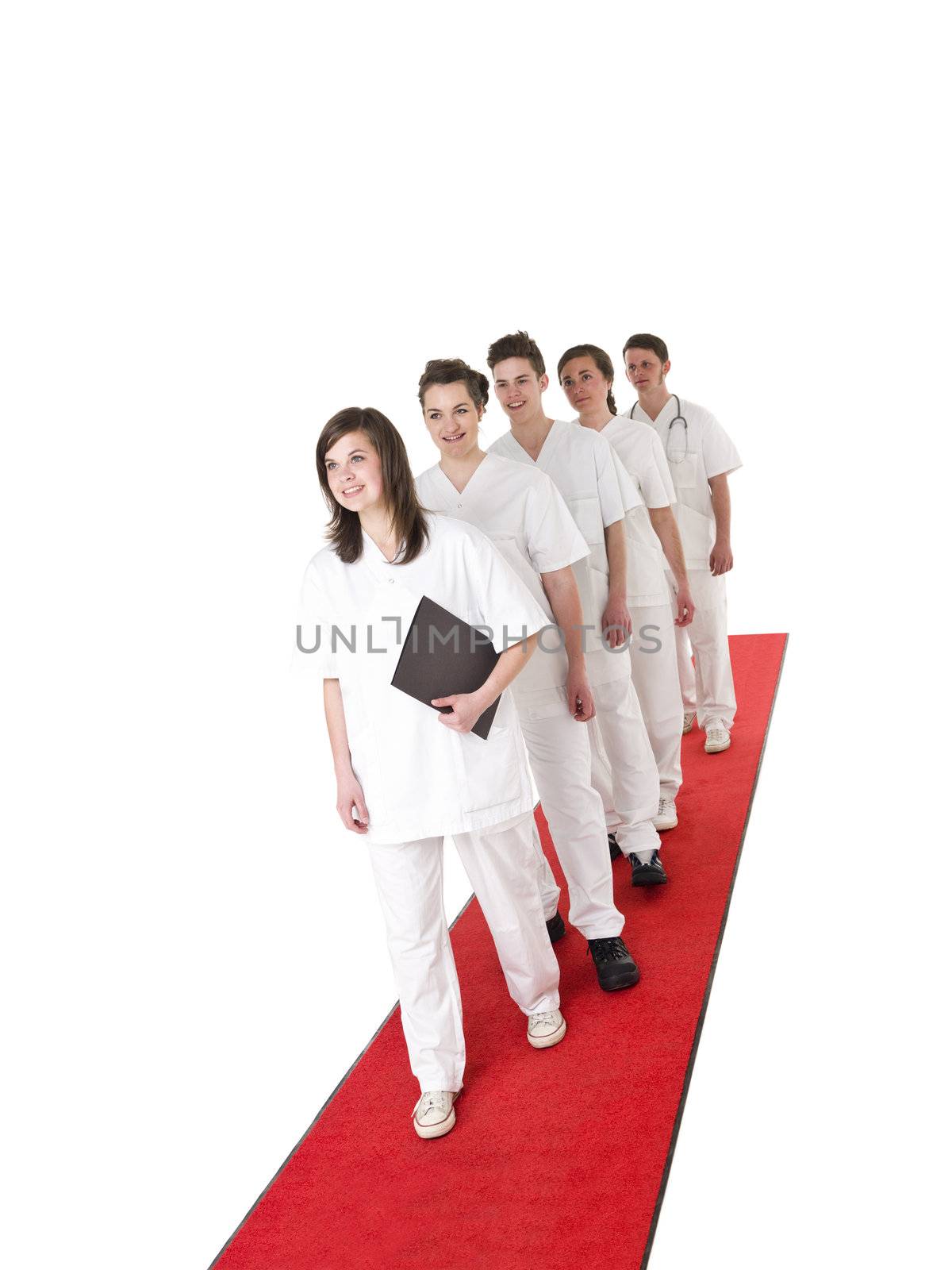 Doctor and Nurses on a red carpet isolated on white background