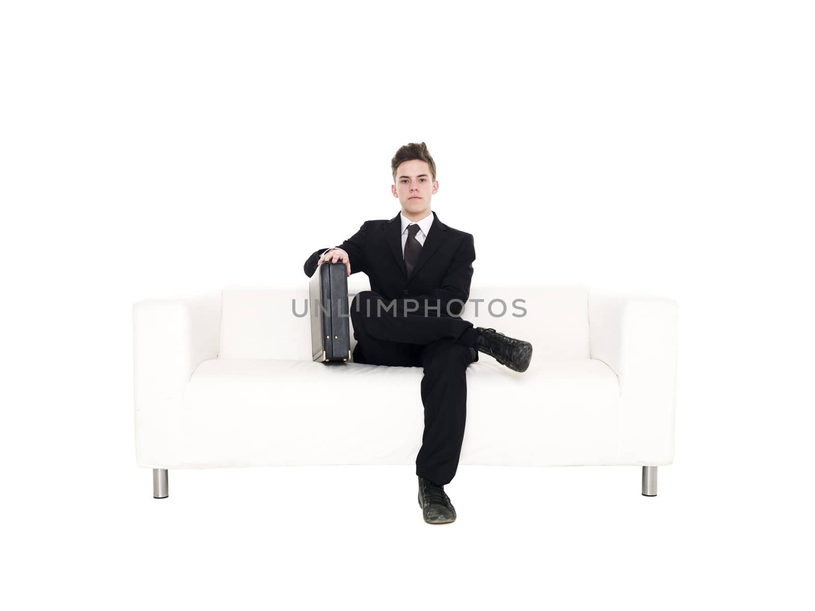 Businessman sitting in a sofa isolated on white background