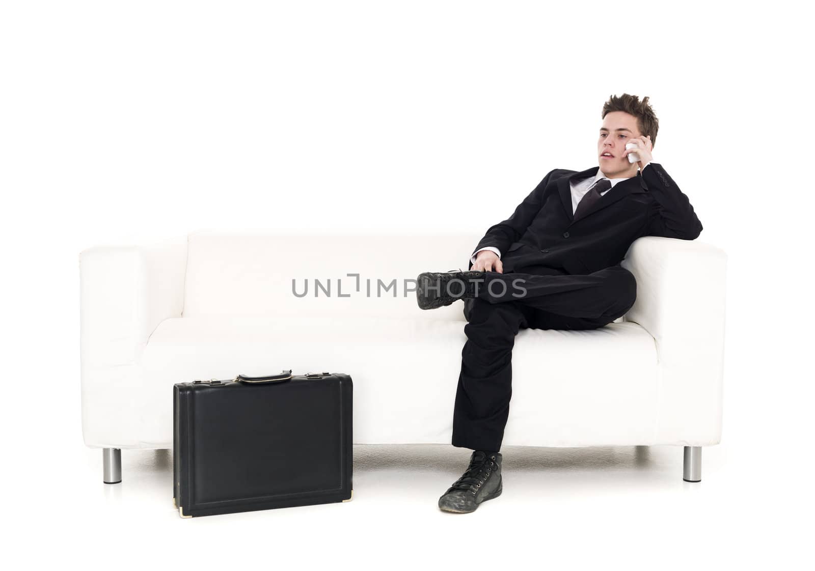 Businessman sitting in a sofa by gemenacom