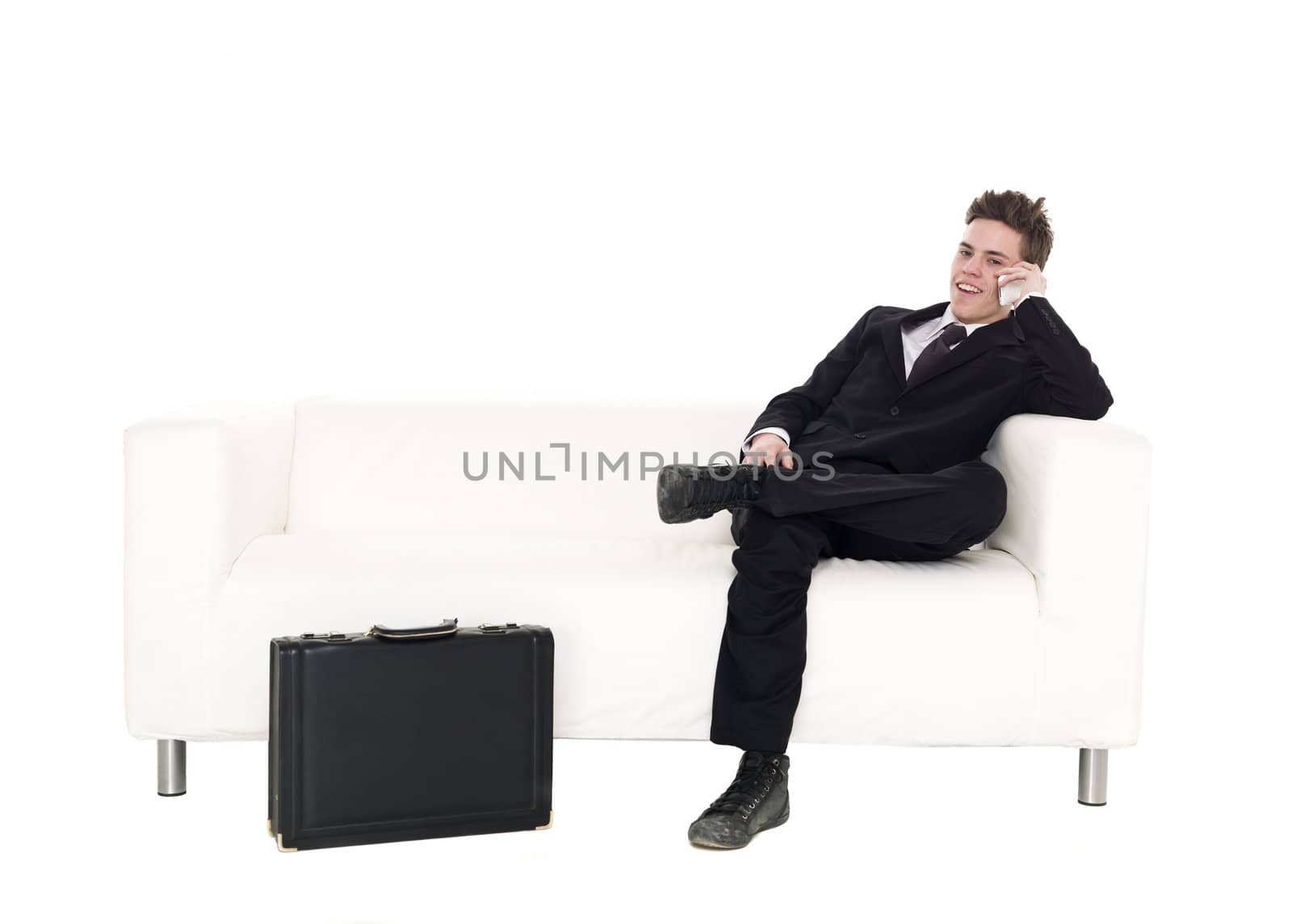 Businessman sitting in a sofa isolated on white background