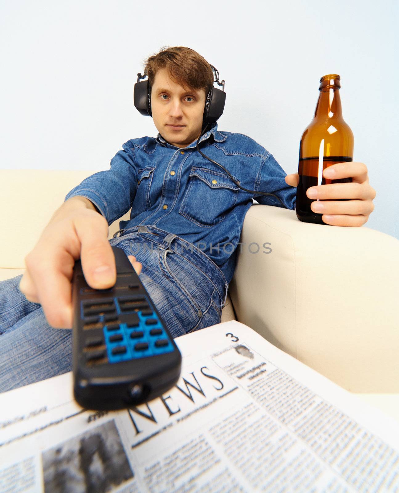 Young man sitting on the couch watching TV