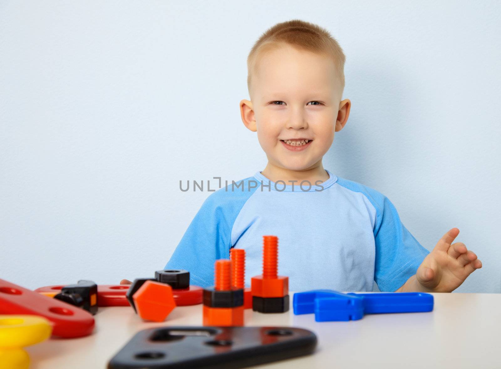 A happy child playing with toy instruments
