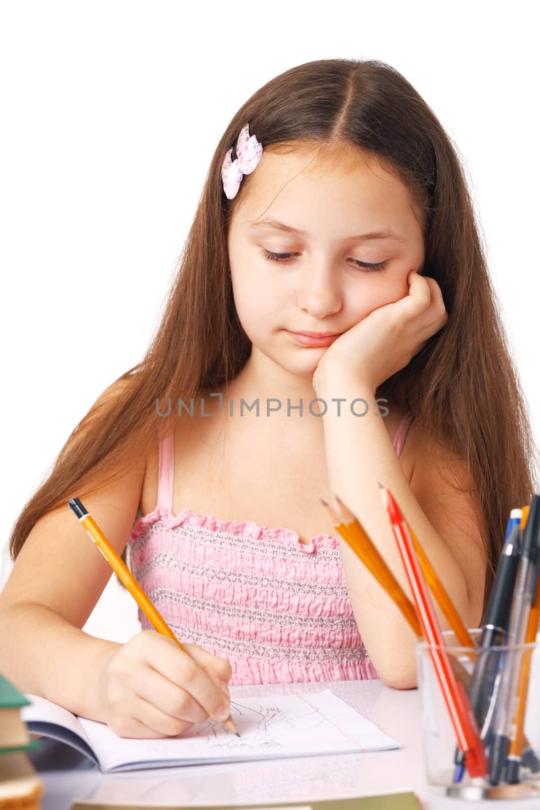 Cute little girl sketching something in the copybook
