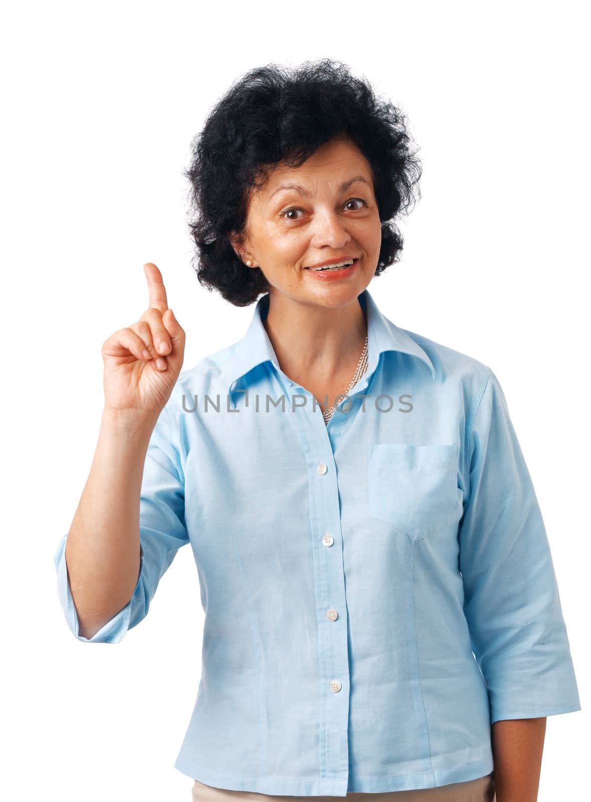Portrait of a  happy senior woman pointing upwards on white. 