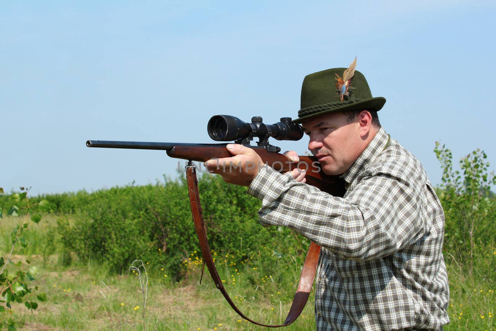 hunter aiming with sniper rifle