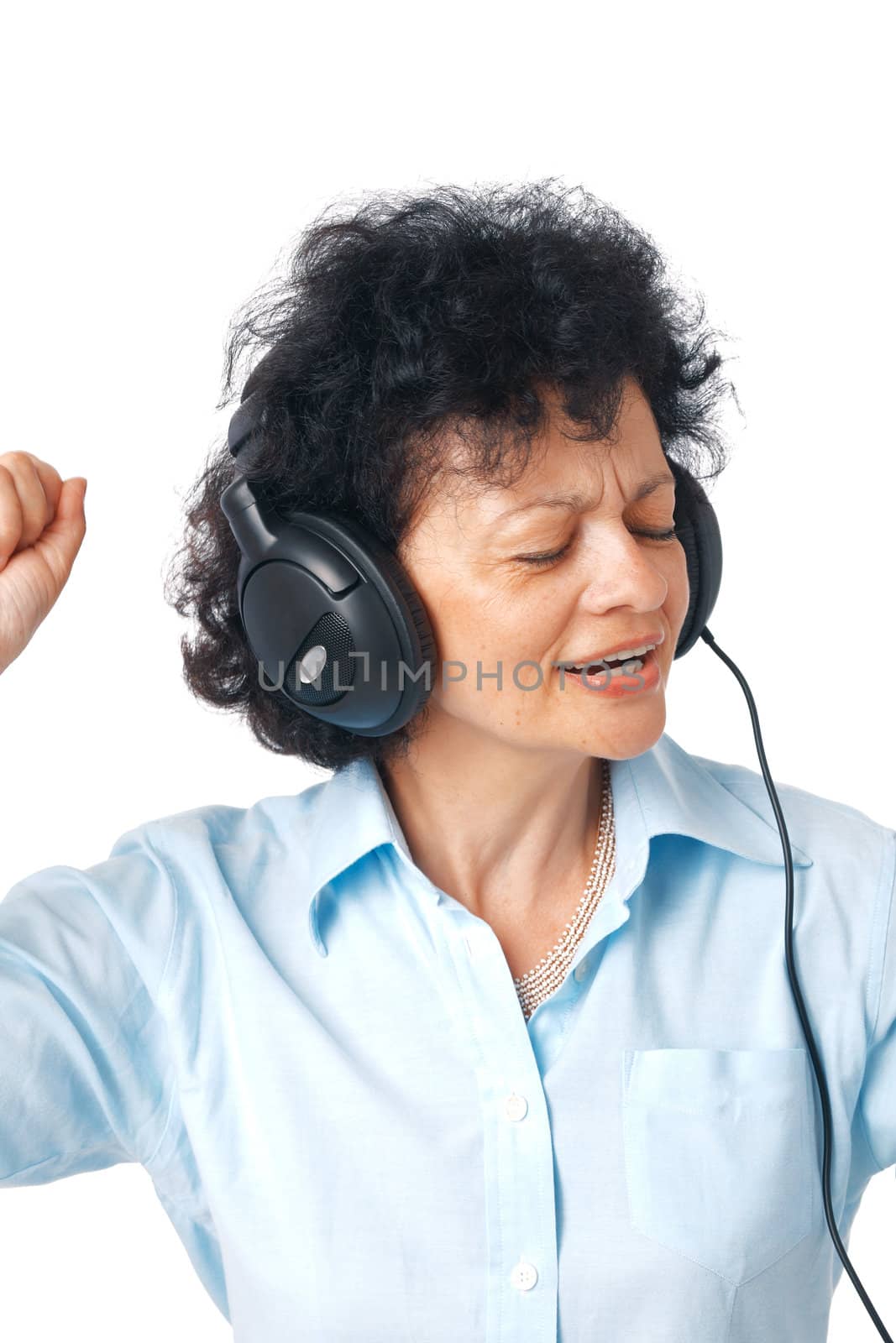 Active happy senior woman enjoying music over white background.