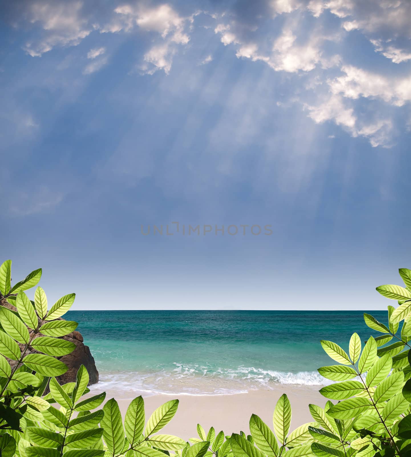 Summer paradise view with green foliage, beautiful beach, emerald color sea and rays from heaven