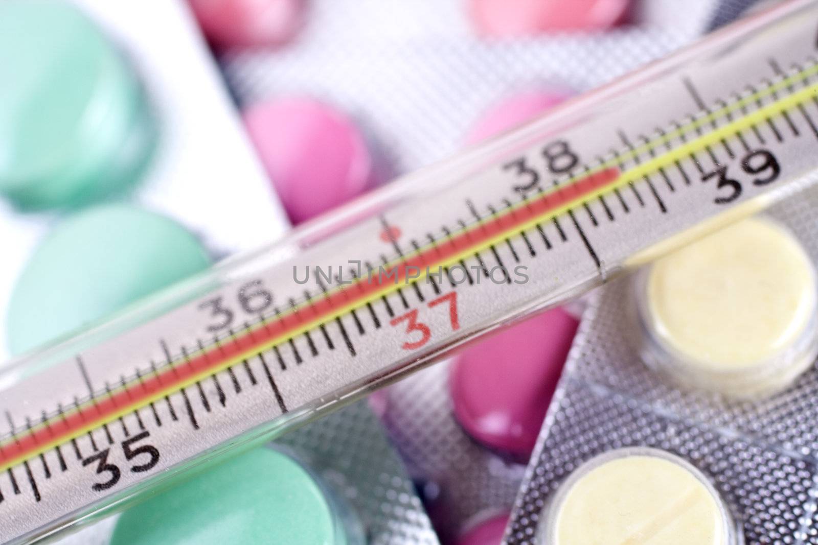 thermometer and pills as a background
